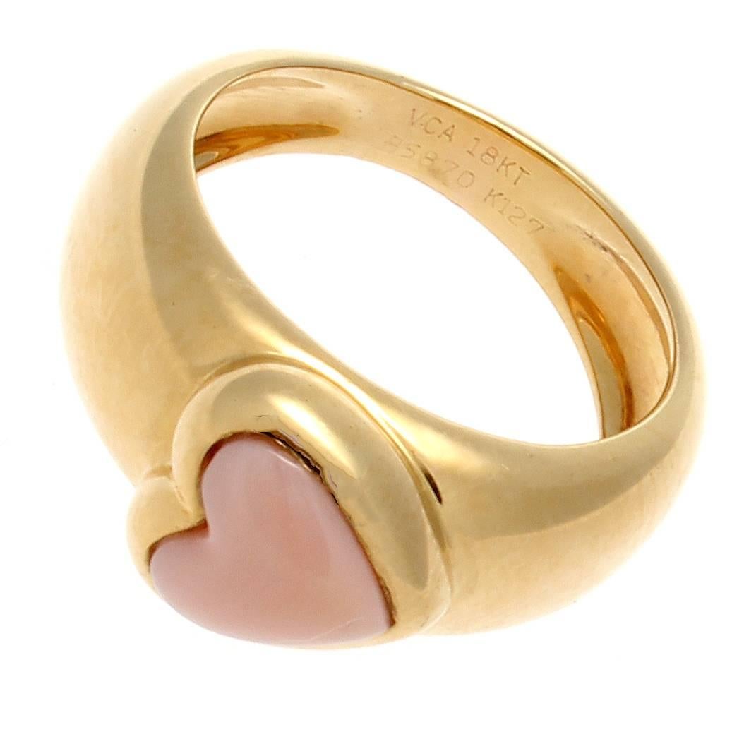 Van Cleef & Arpels, a long rich history of trend setting fashion that is still relevant today. This ring has been fashioned with an adorning heart shaped angel skin coral. Crafted in 18k yellow gold. Signed VCA and numbered.

Size 4 and may be