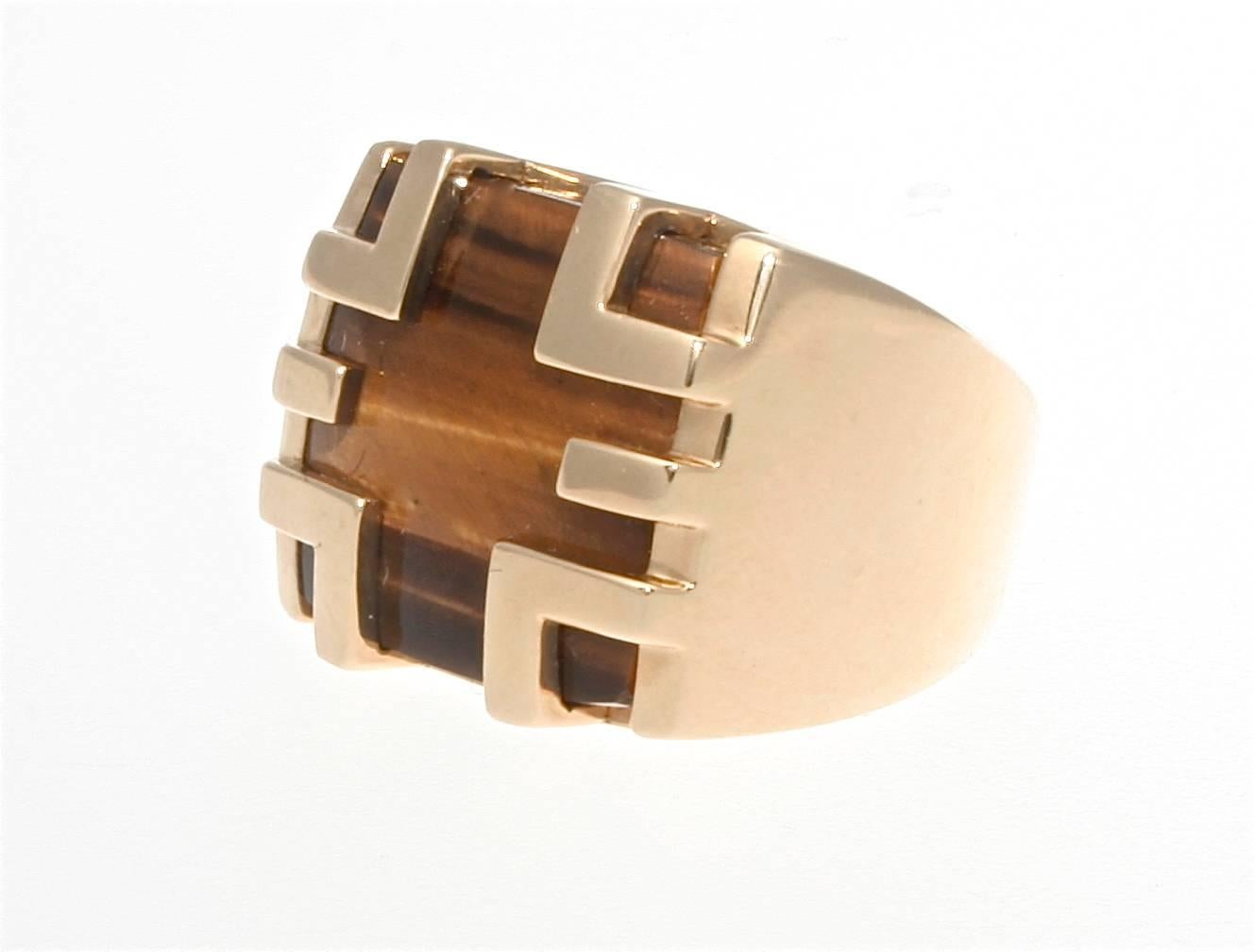 An unusual design from Cartier featuring tigers eye which displays a variety of brown hues. The 18k yellow gold has been fashioned to cage in the tigers eye, displaying why Cartier developed the name of this ring. 

Signed Cartier.

Size 6