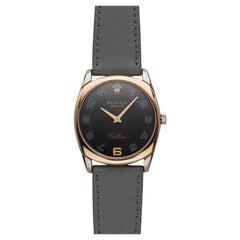 Rolex Cellini de 2000, réf. 4233, en or rose bicolore, cadran noir à chiffres arabes, remontage manuel, 34 mm