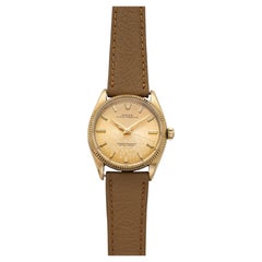 Rolex Oyster Perpetual 1005 vintage de 1960, or jaune 18 carats, cadran patiné couleur champagne, mouvement automatique, 34 mm