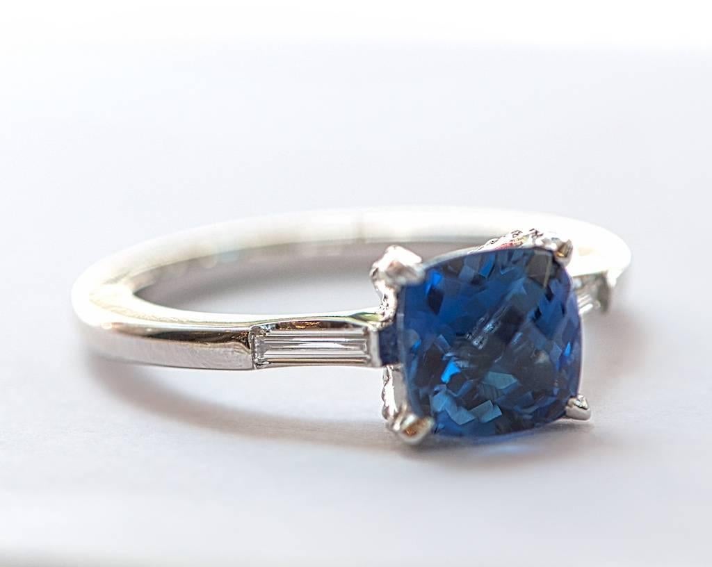 Handmade platinum and diamond setting with a two carat cushion cut sapphire as the center stone.
Slender baguettes totaling 0.13 cts.
Micro-pave set diamonds in the prongs, totalling 0.08 cts.

This sleek, pristine setting looks stunning with the