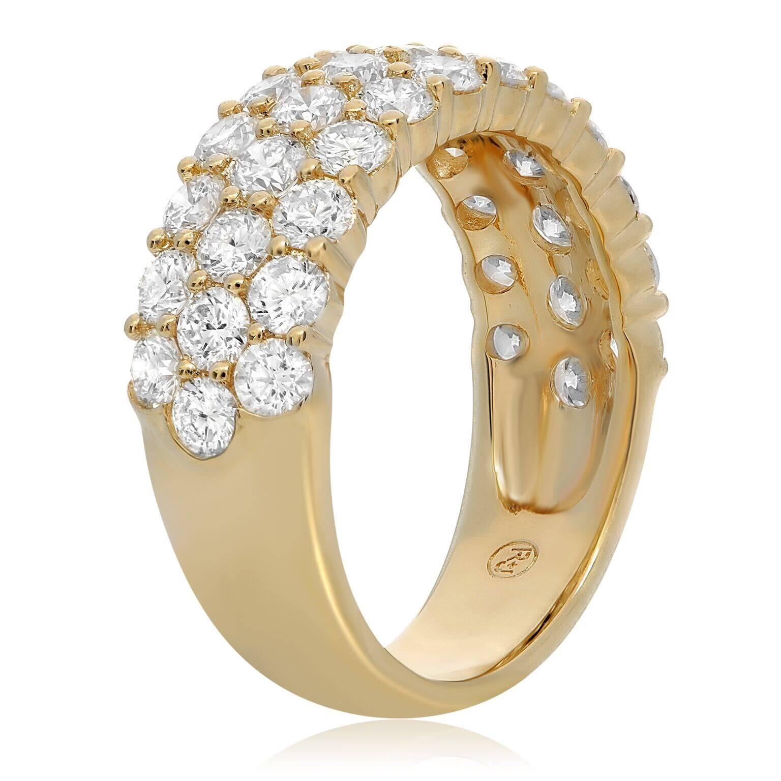 Three rows of pave diamonds set in an 18K yellow gold band. Three rows of round cut white diamonds that total 2.40 cts are featured along the front of the band. This band ring can be added to a bridal jewelry suite. Also makes a perfect gift.