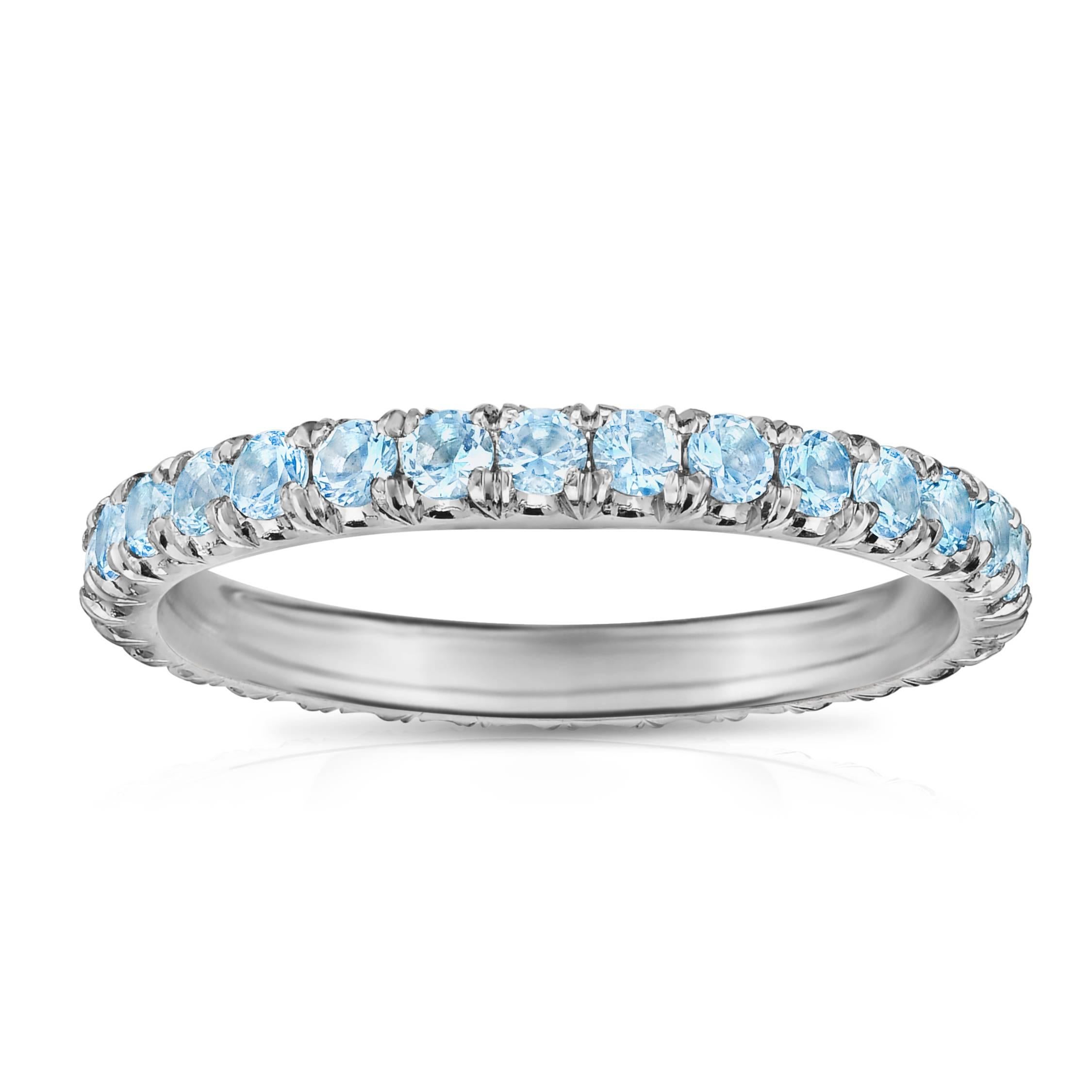 Marisa Perry's three point aquamarine eternity band in platinum makes the perfect wedding ring. Eternity rings are also popular as push presents and anniversary gifts. Aquamarine is the March birthstone making this micro pave Aquamarine eternity