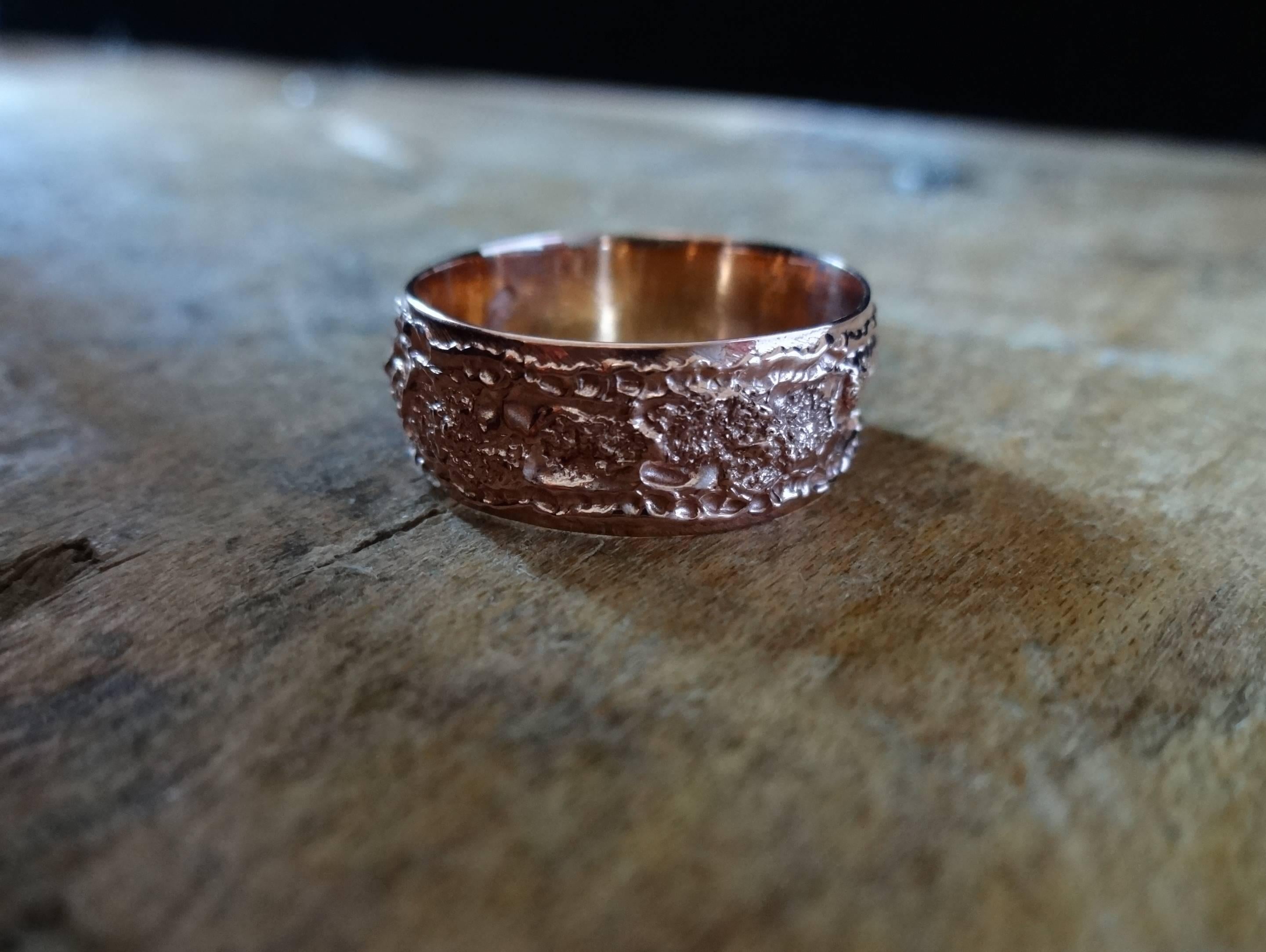 
Edgy band ring with an organic edge. An exploration of texture and surface dynamics, this ring was created using manipulation techniques to create uneven dimensions and areas of different granualization and light refraction, all bordered by a fine,
