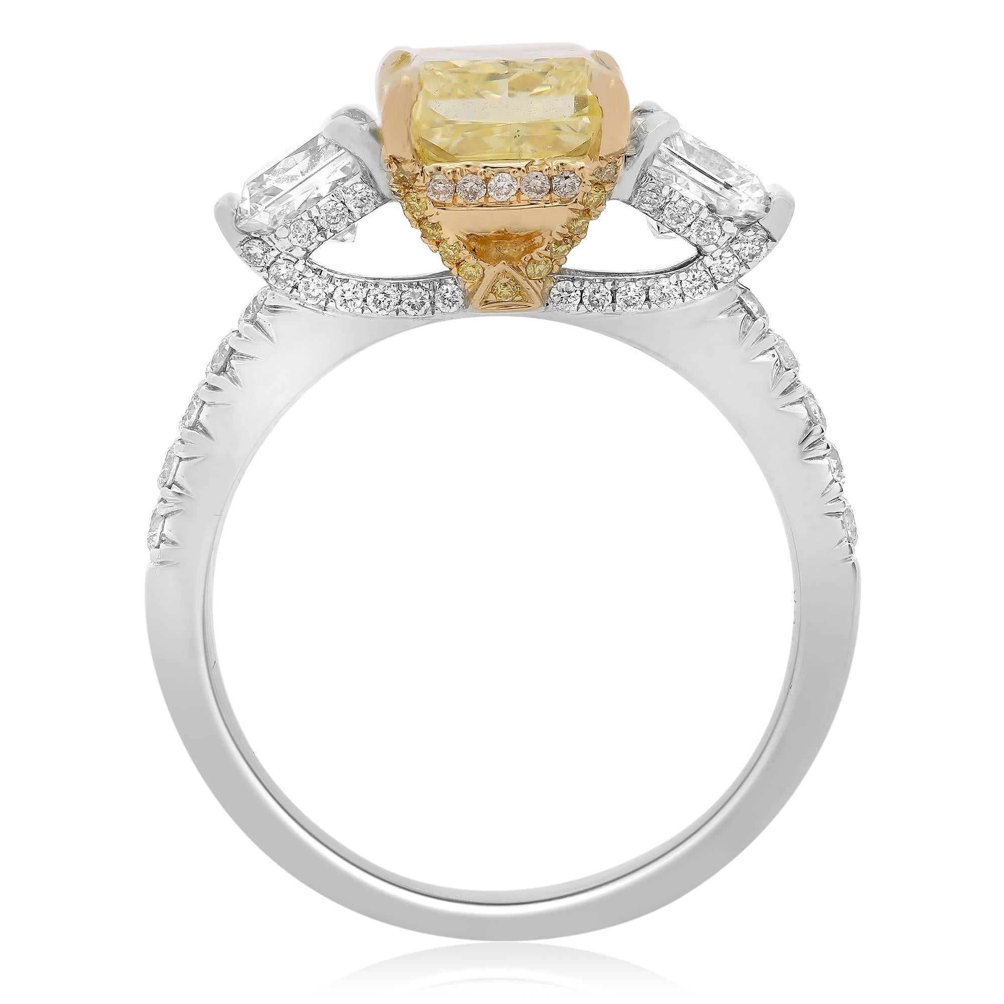 Three stone ring features Fancy Intense Yellow colored Radiant Cut Diamond with two radiant cut diamonds on both sides. Perfect as a three stone engagement ring with pave diamonds running one-quarter way down the shank and around the basket.