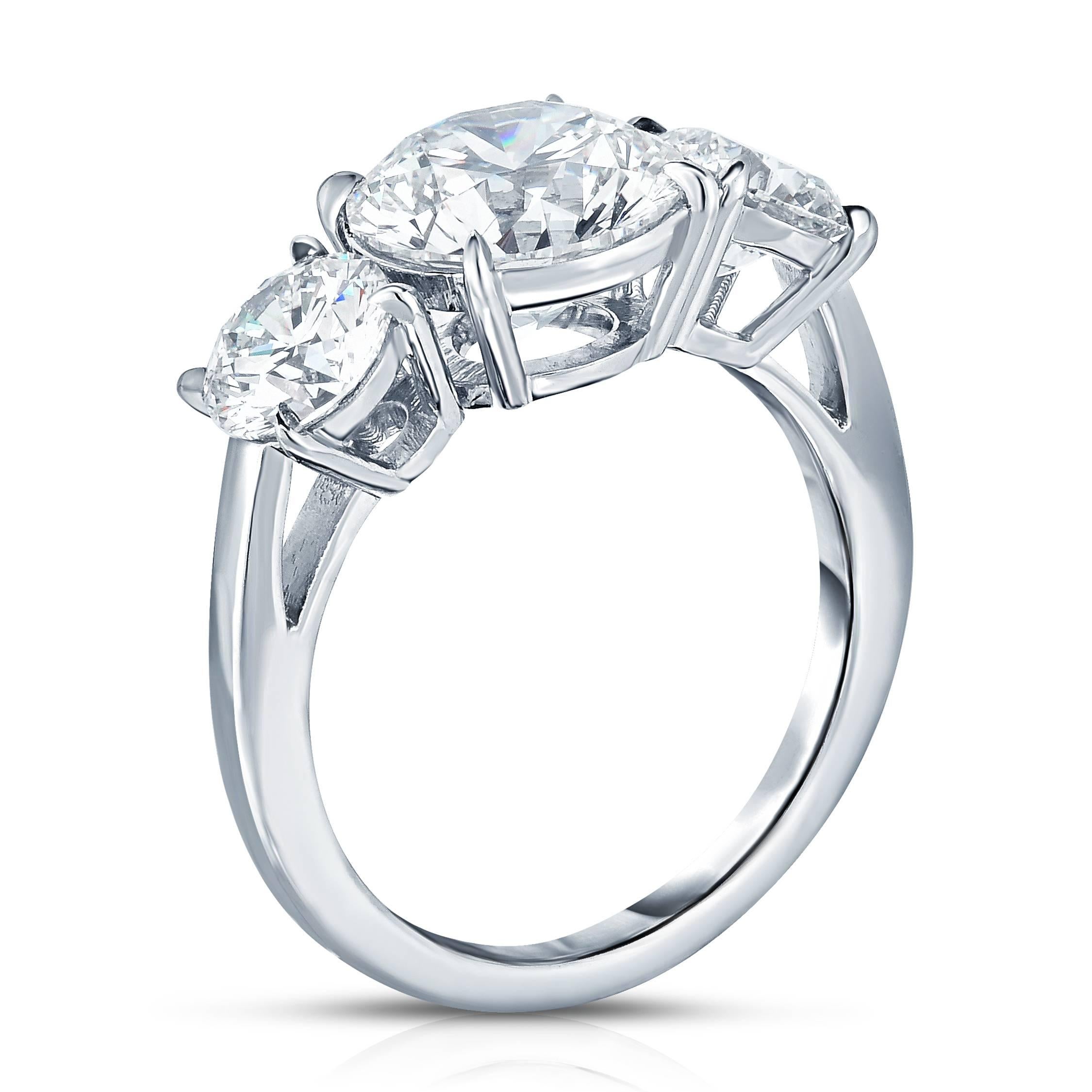  2.57 carat Round Brilliant Diamonds with two 0.70 carat Forevermark Round Diamonds in platinum. Designed as a three stone engagement ring.  

 This elegant engagement ring was beautifully sculpted in platinum by as master jeweler who crafted the