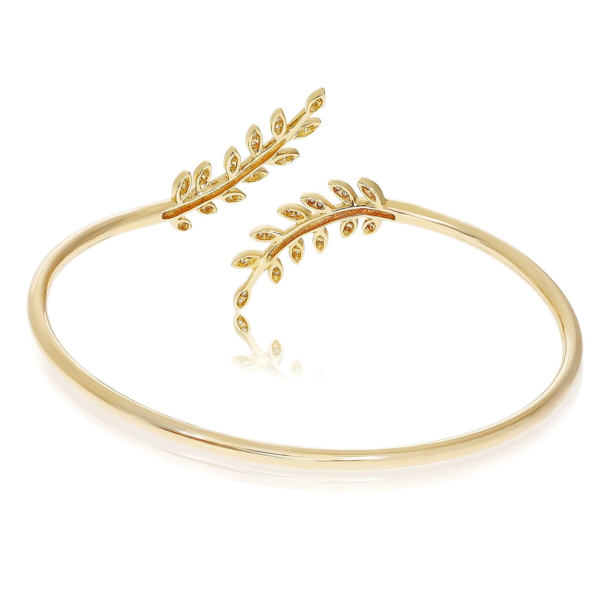 Cuff bangle in yellow gold in leafy pattern with pave set diamonds. Delicate, feminine and classically elegant this yellow gold and diamond cuff bracelet is reminiscent of ancient Roman olive branch motifs. This cuff bracelet contains 0.18 carats of