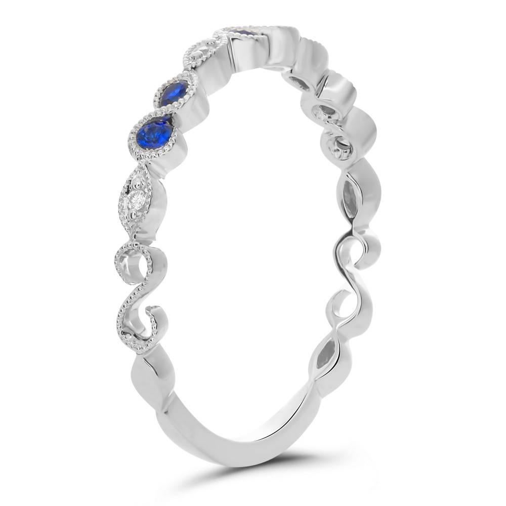 Blue Sapphire and Diamond Band Ring in 14kt white gold with milgrain edges. 
This ring contains 0.02 carats of Round Brilliant Diamonds and 0.17 carats of Round Blue Sapphires. Perfect as a birthstone present for the holidays. Remember that Sapphire