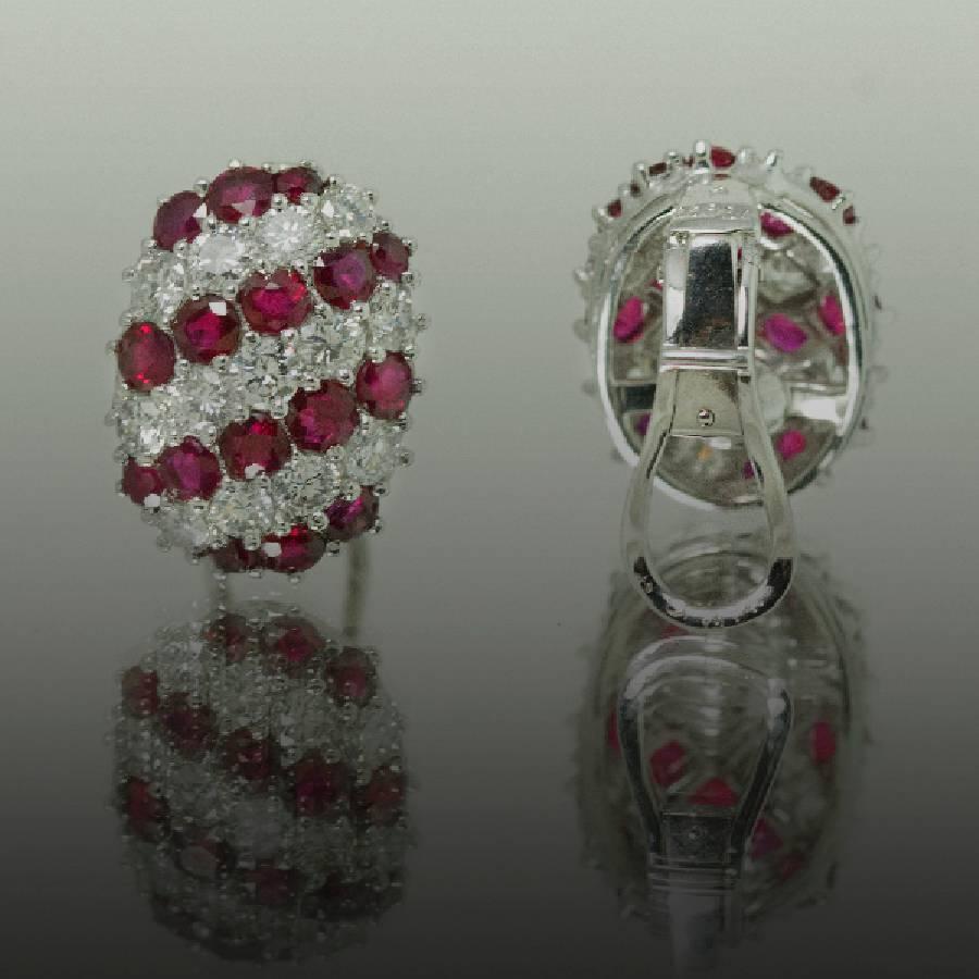Stunning platinum Earrings with 32 round vivid red rubies weighing 4.82 carats and 26 collection color clarity round brilliant diamonds weighing 3.10 carats. 