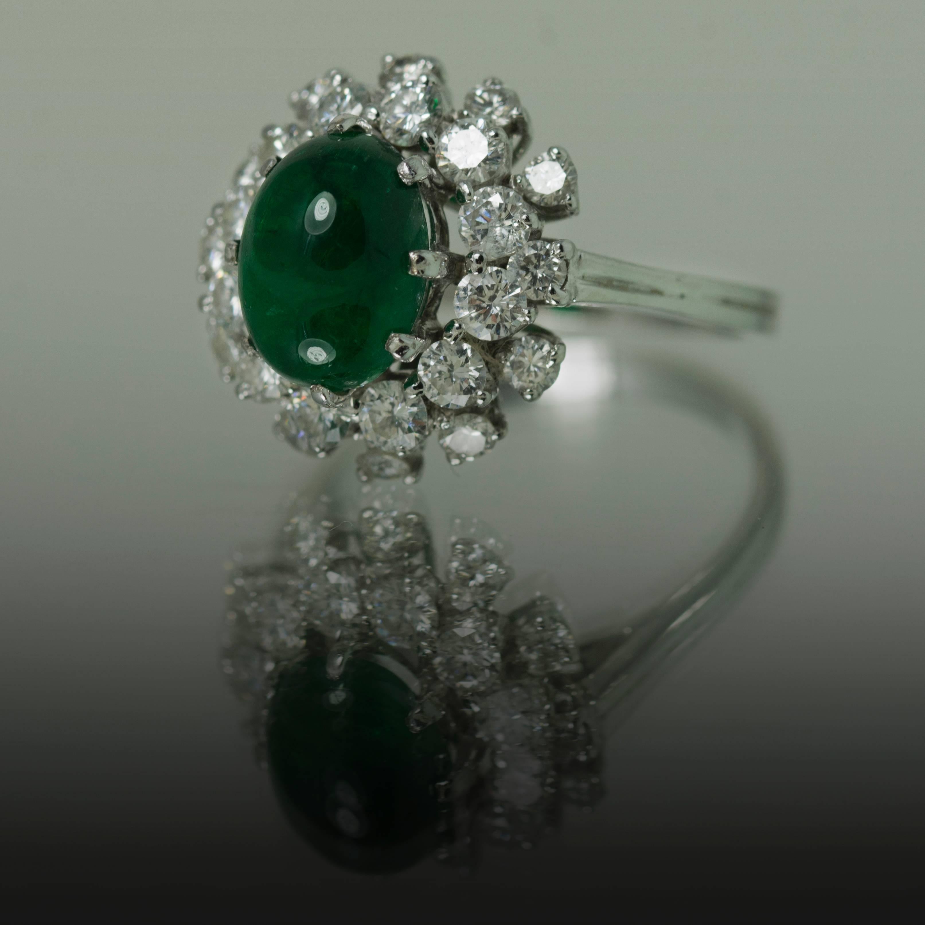 Beautiful Platinum Ring with super gems 3.23 carat Colombian Emerald cabochon and 24 fine round brilliant diamonds weighing 1.06 carats.