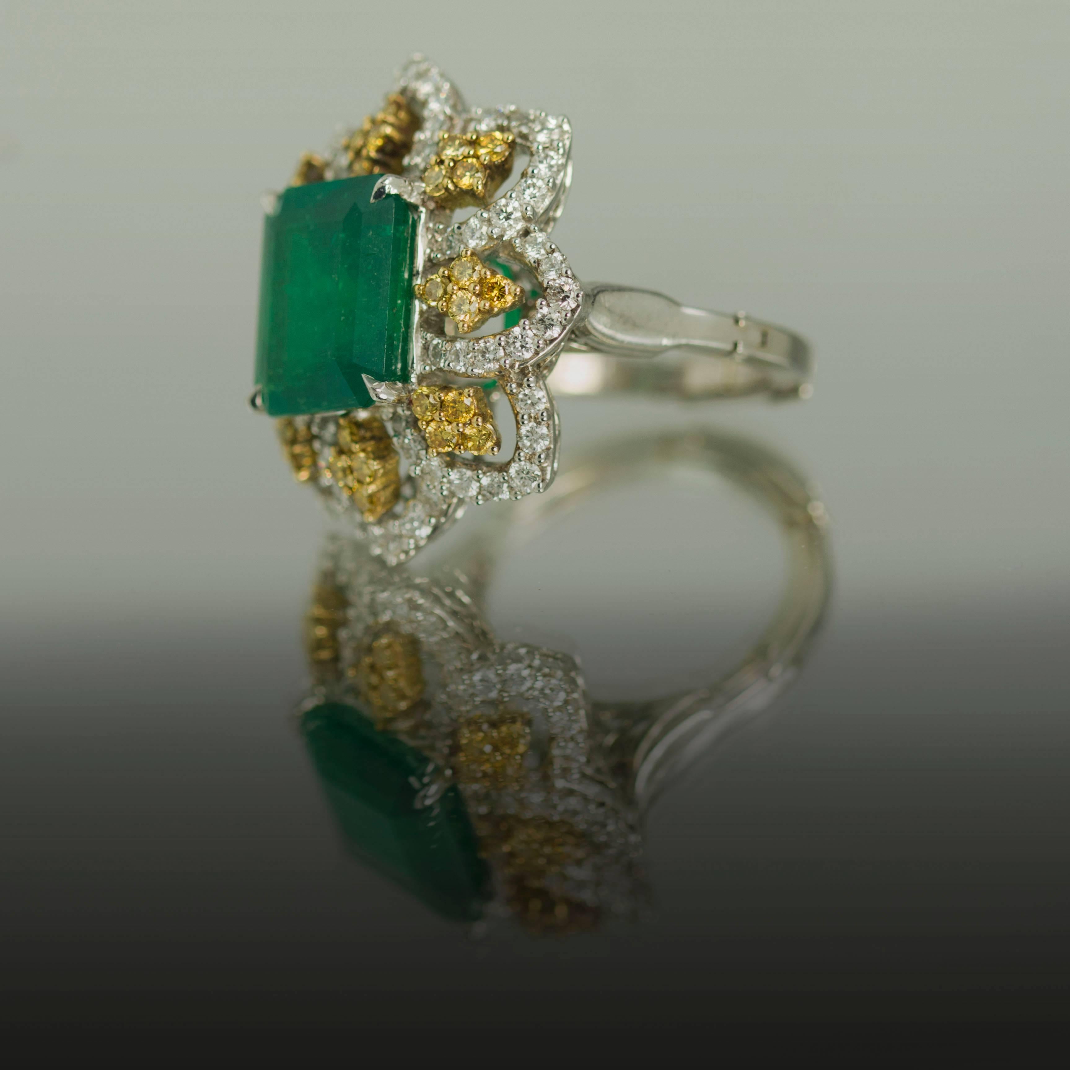 Platinum ring with 1 Colombian Emerald weighing 5.84 carats and 64 white round brilliant diamonds weighing 1.28 carats and 32 intense yellow round brilliant diamonds weighing 0.64 carats. Size 5 (Free Sizing)
 