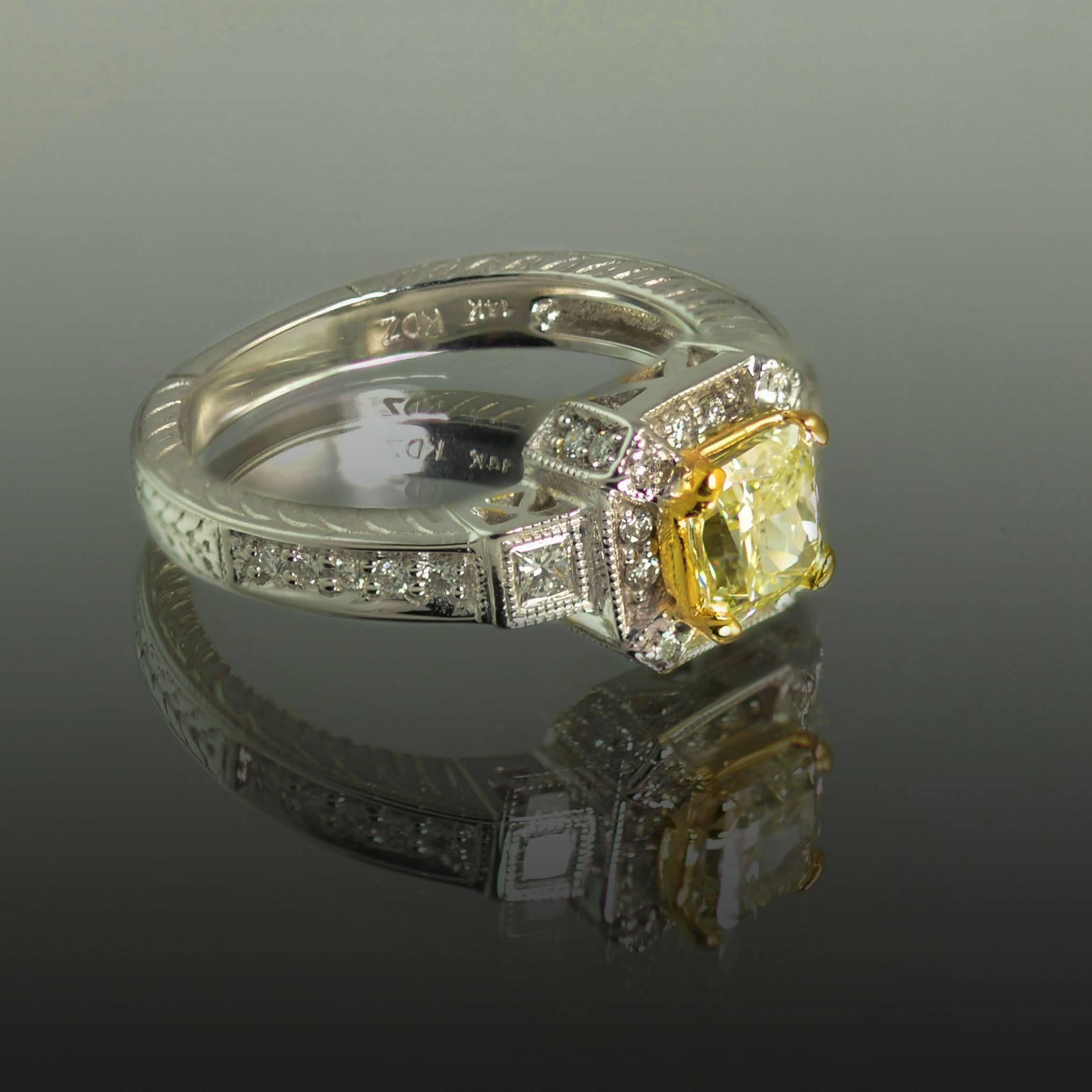 14k Ring with 1 radiant cut yellow diamond weighing 1.03 carats, 32 round brilliant and 2 princess cut diamonds weighing approximately 0.40 carats. 

This diamond is not certified, however our in house gemologists have graded the center stone as