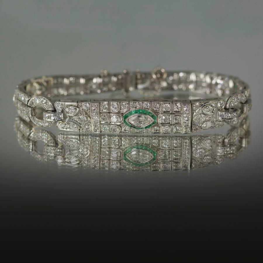 Platinum Art Deco Bracelet circa 1930 Old Euro and Marquis cut diamonds approximately 9.00 carats Emeralds approximately 0.50 carats. 7 1/4"