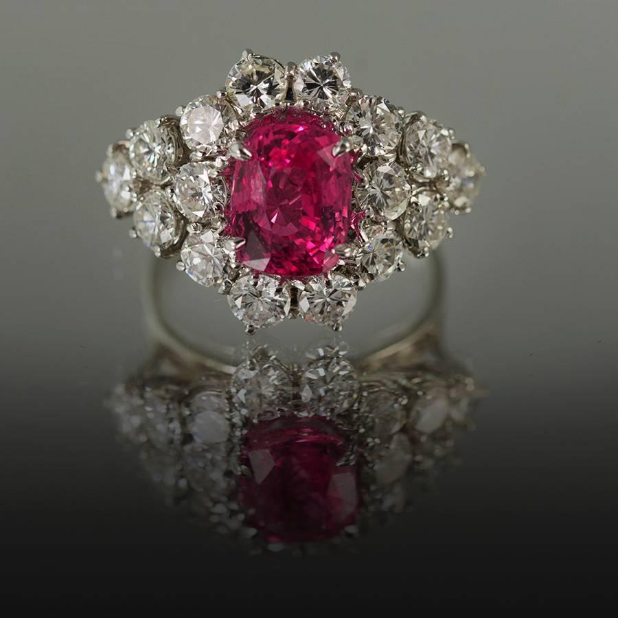 18kw  Ring, 1 GIA Certified No Heat Pink Sapphire weighing  3.24 carats and  16 round diamonds weighing  3.26 carats.

YouTube video available upon request.


