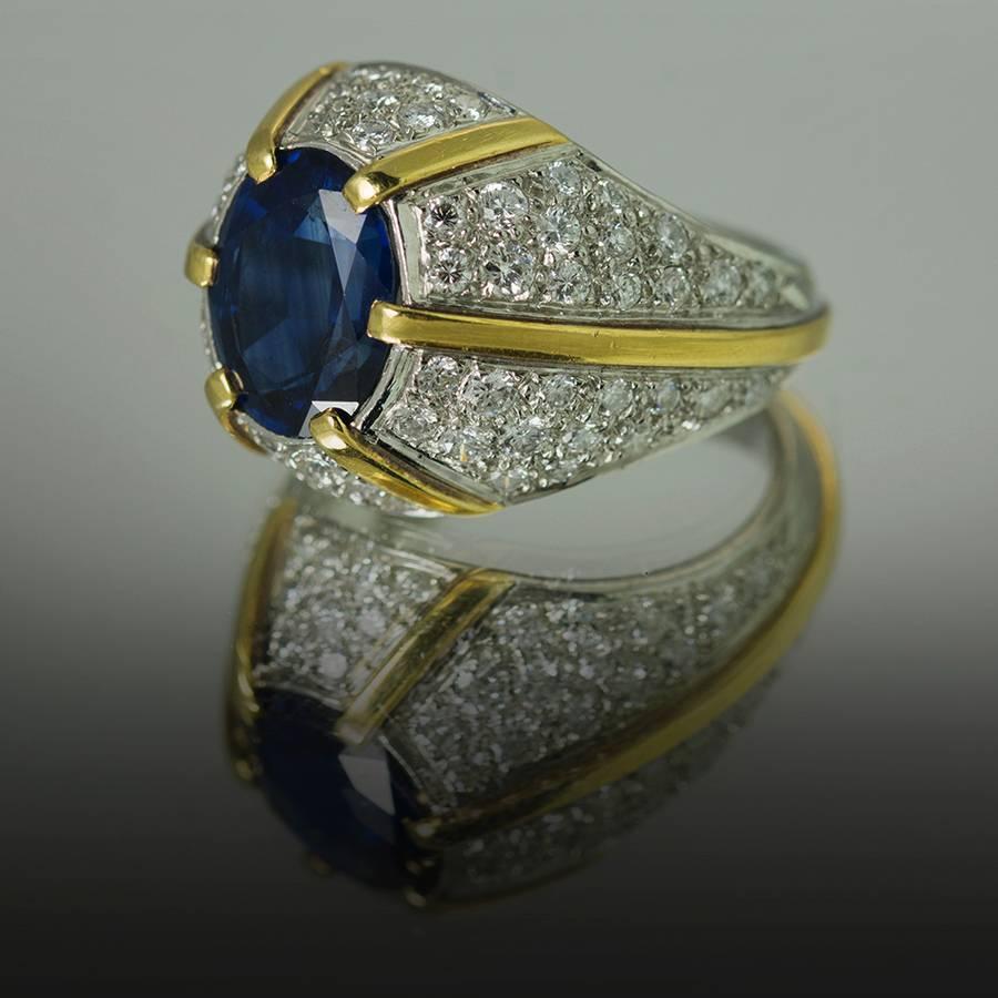 Platinum & 18k Dome Ring set with 1 Blue Sapphire weighing 5.08 carats and high color high clarity round brilliant diamonds weighing approximately 2.60 carats.