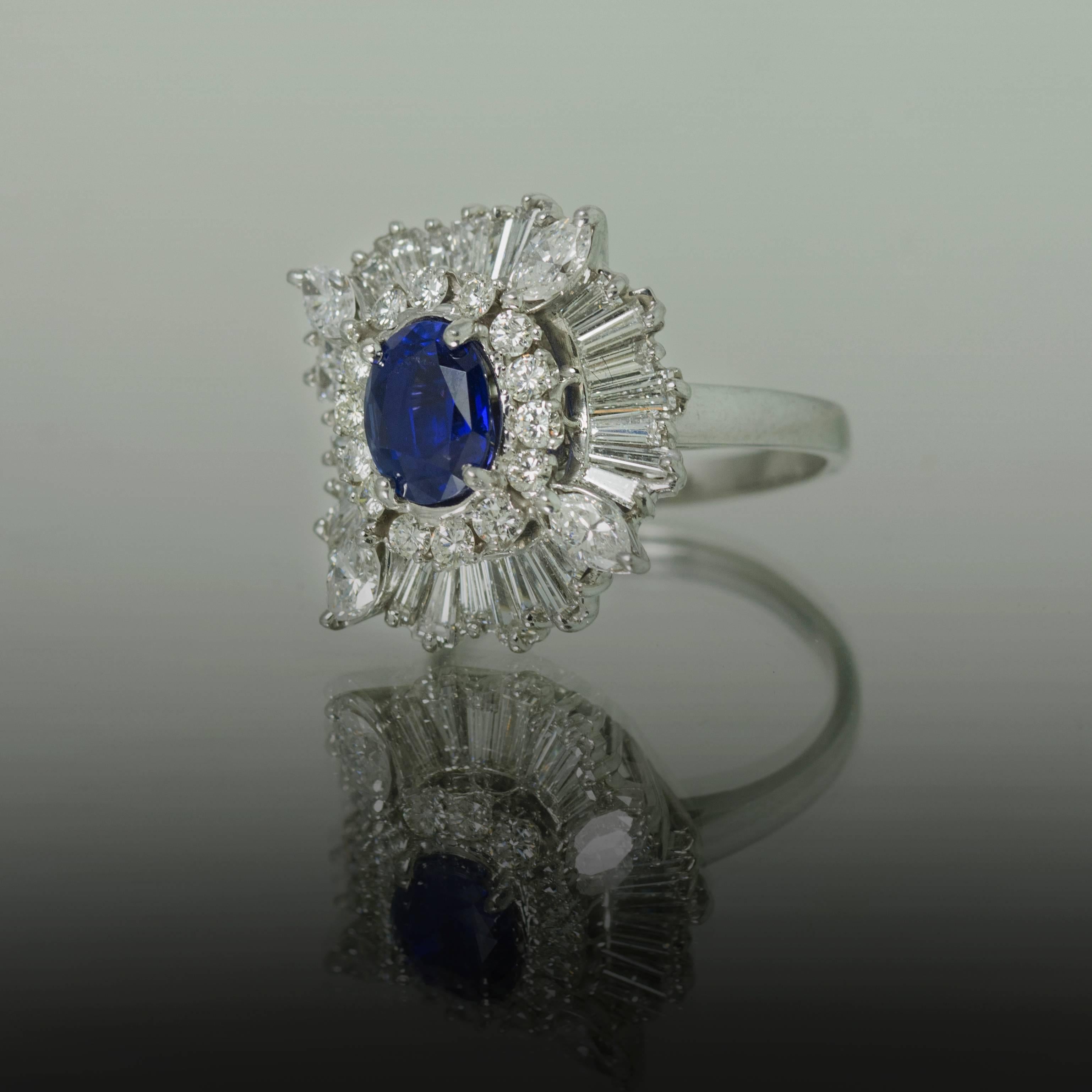 Platinum Ring with 1 Royal Blue Ceylon Sapphire weighing 2.61 carats and high color, high clarity tampered baguette and modern round brilliant diamonds weighing approximately 4.16 carats.