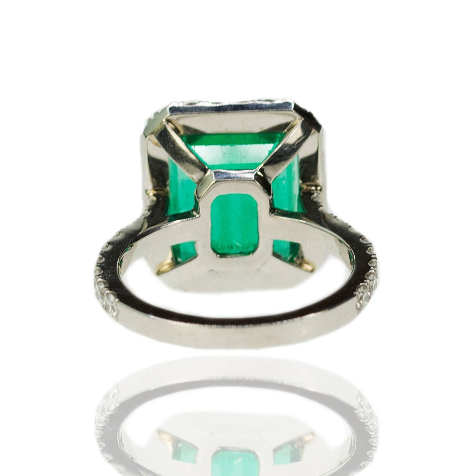 Ring with 6.64 carat AGL certified "Minor" Colombian Emerald set in 18k mounting with 1.40 carats of round brilliant diamonds. 8.27g