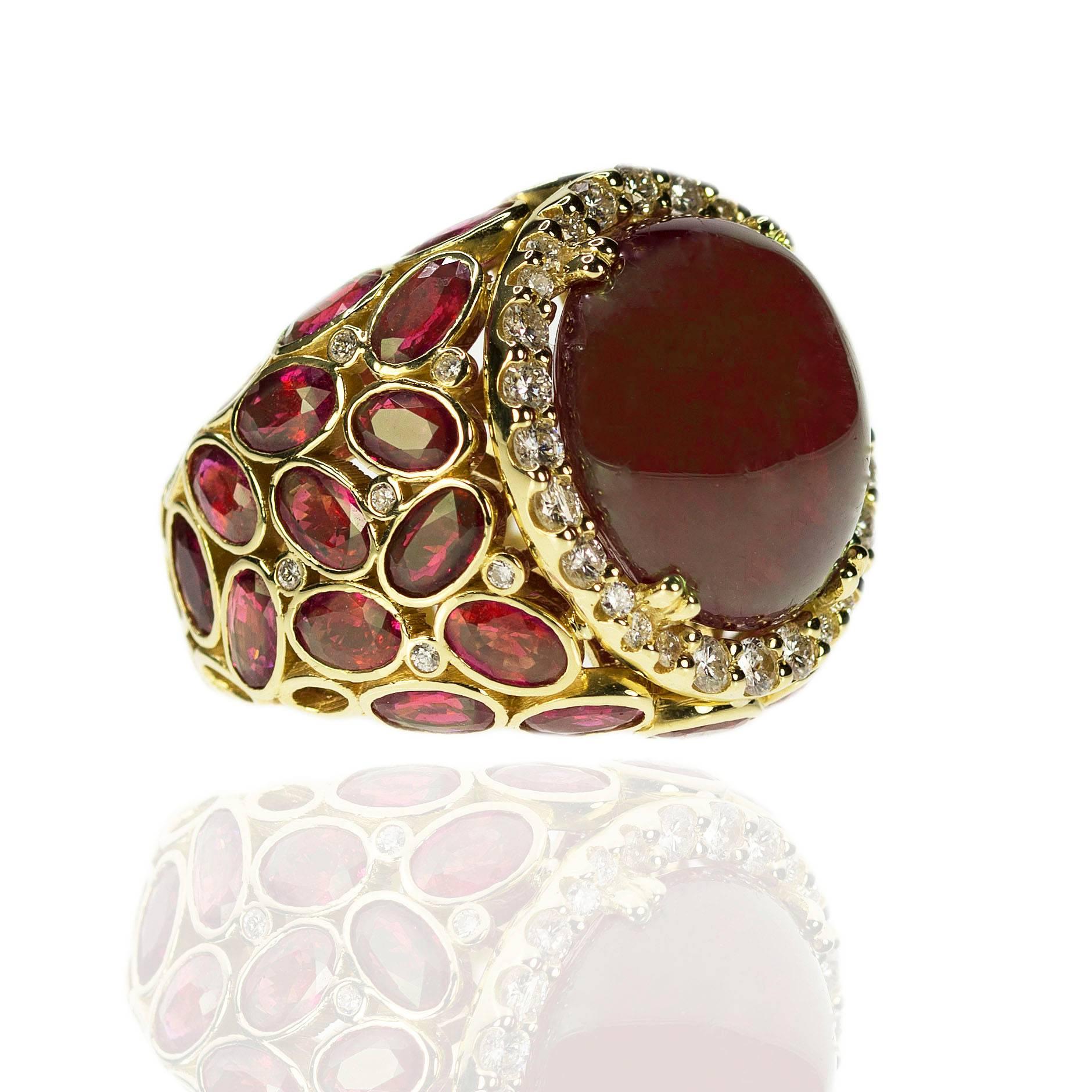 18k Ring with AGL certified 21.43 carat, cabochon cut, no heat Burma Ruby and 30 oval rubies weighing 8.27 carats and 40 round brilliant diamonds weighing 0.87 carats. 19.59gGold 