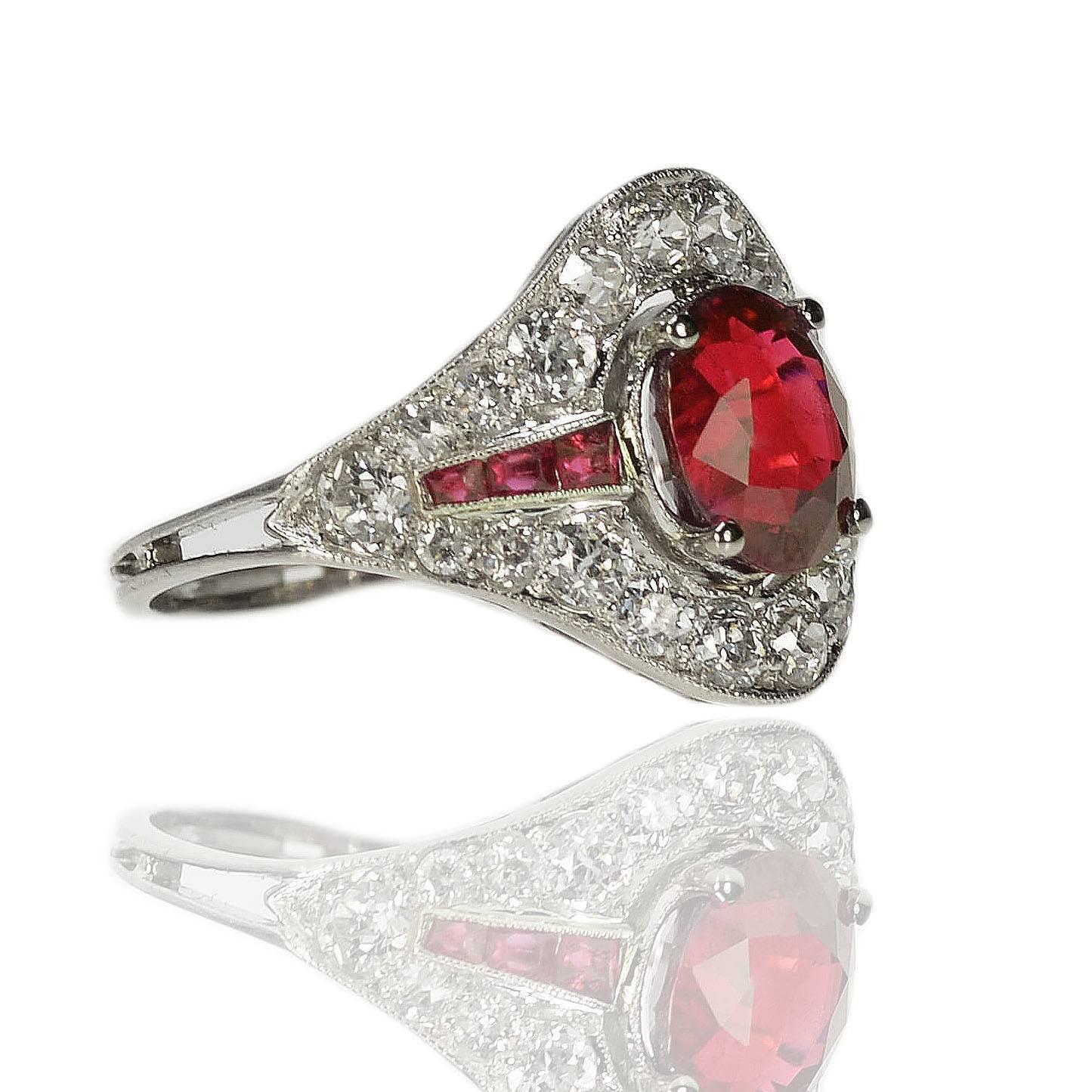 Fabulous platinum Art Deco ring with AGL certified 2.18 oval carat Burma Ruby and six square rubies weighing approximately 0.50 carats and approximately 1.25 carats of high quality old euro cut diamonds.
