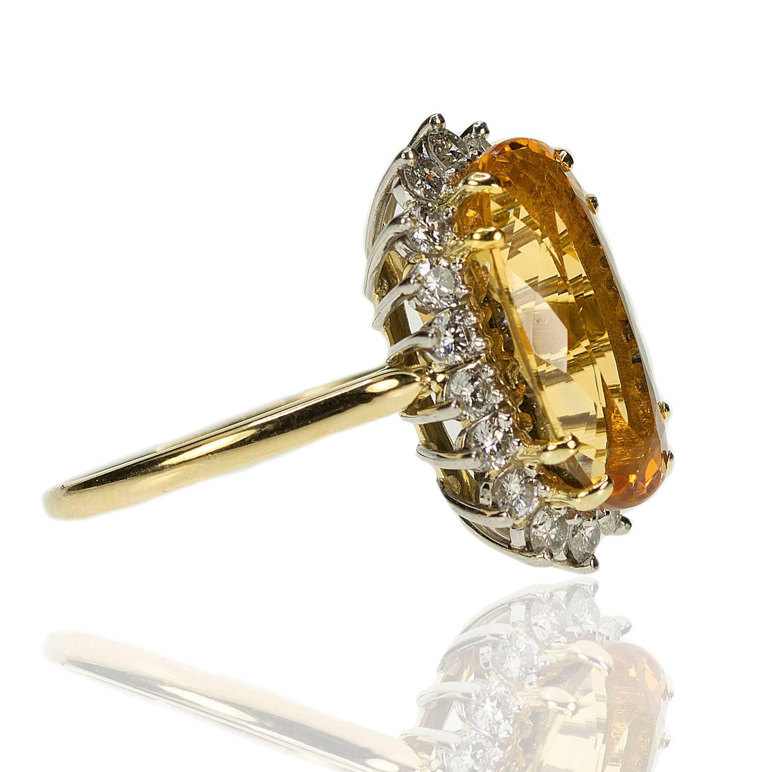 18k & Platinum Ring with approximatel 8.50 carat Imperial Topaz and 18 modern round brilliant diamonds weighing approximately 1.00 carats/ 8.02g