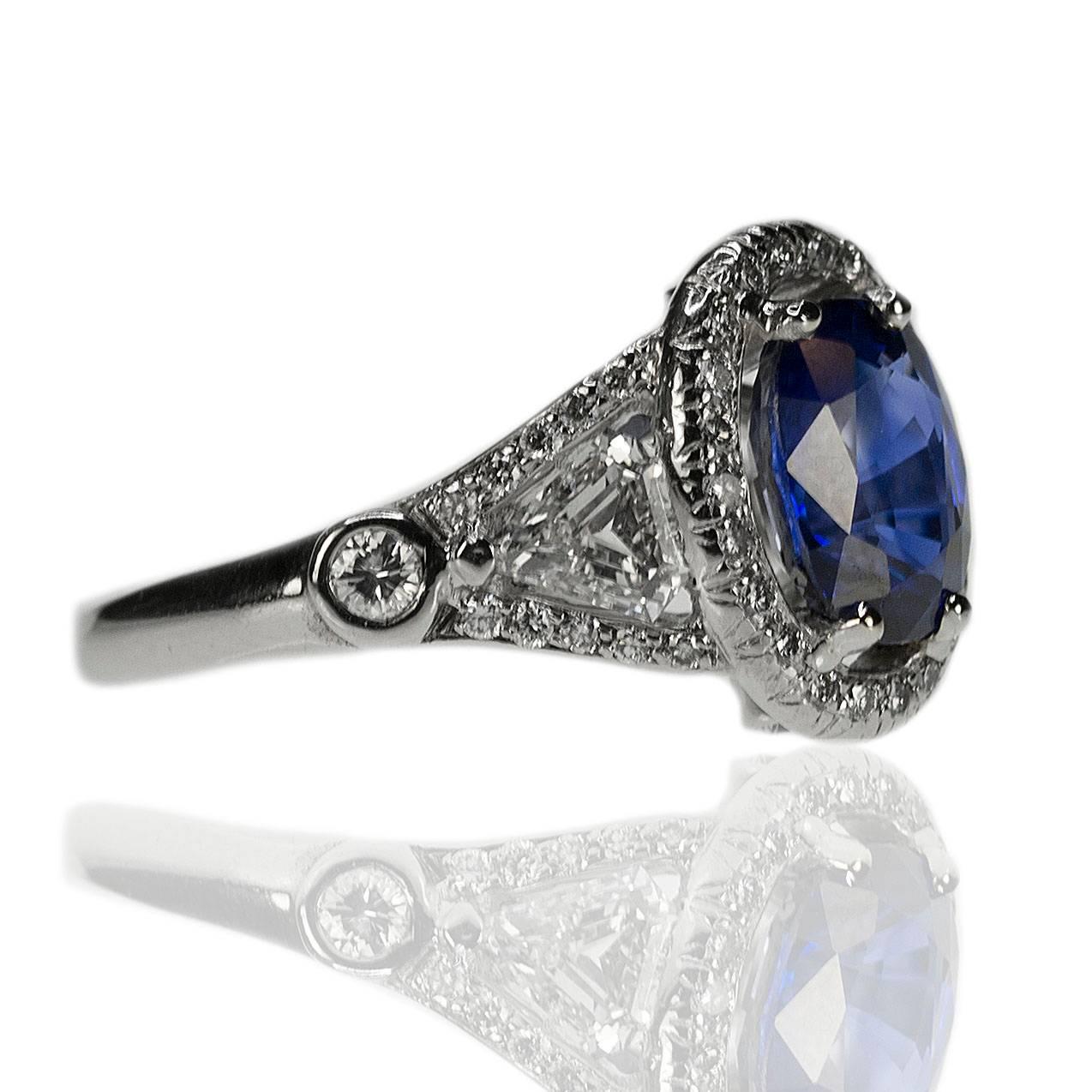 Stunning Platiunm Antique Ring with one 1 AGL certified Madagascar Sapphire weighing 1.90 carats and two Calf Head cut diamonds weighing approximately 0.70 carats as well as sixty four round diamonds weighing approximately 0.45 carats.  6.68g