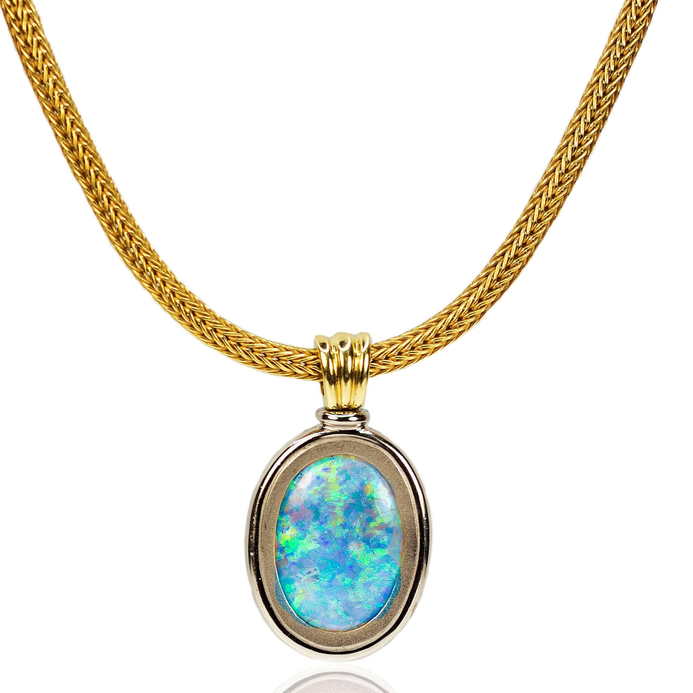 Magnificent Necklace with reversible double sided Australian Opal weighing approximately 15 carats and displaying gorgeous blue, green and red flashes of color. Set in 18k and floating on a thick 18k mesh chain. 61.42 grams.