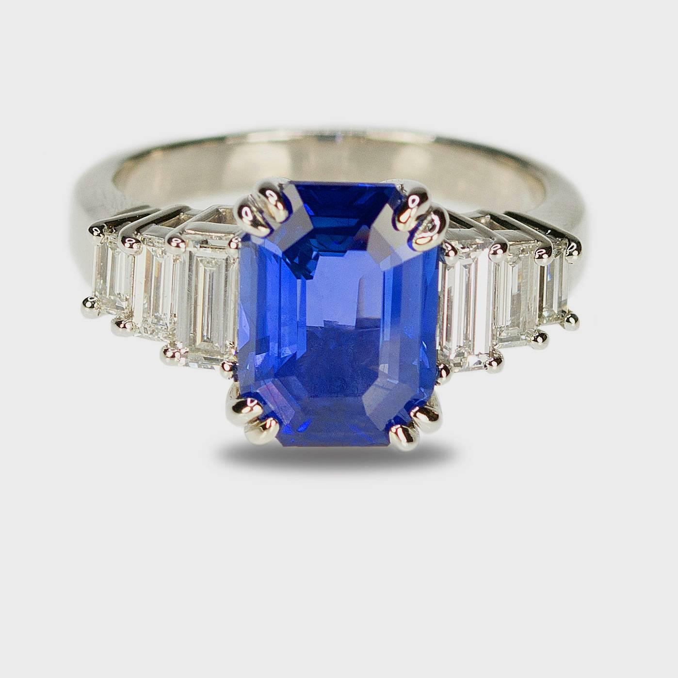 Platinum ring with one AGL certified 3.63 carat "No Heat" emerald cut sapphire and six colorless straight baguette diamonds weighing 0.82 carats. 5.49g