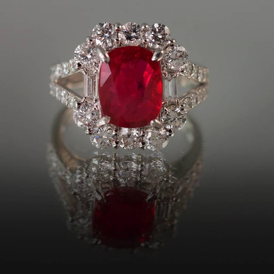 Platinum Ring with GIA certified no heat ruby weighing 3.07 carats and 2 baguette cuts and 26 round brilliant cut diamonds weighing 1.89 carats 
