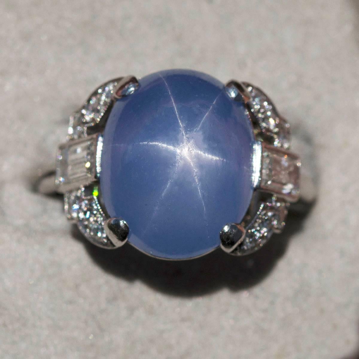 Beautiful Art Deco Platinum Ring with approximately 10 carat sky blue star sapphire and approximately 0.80 carats of baguette and old european cut diamonds.