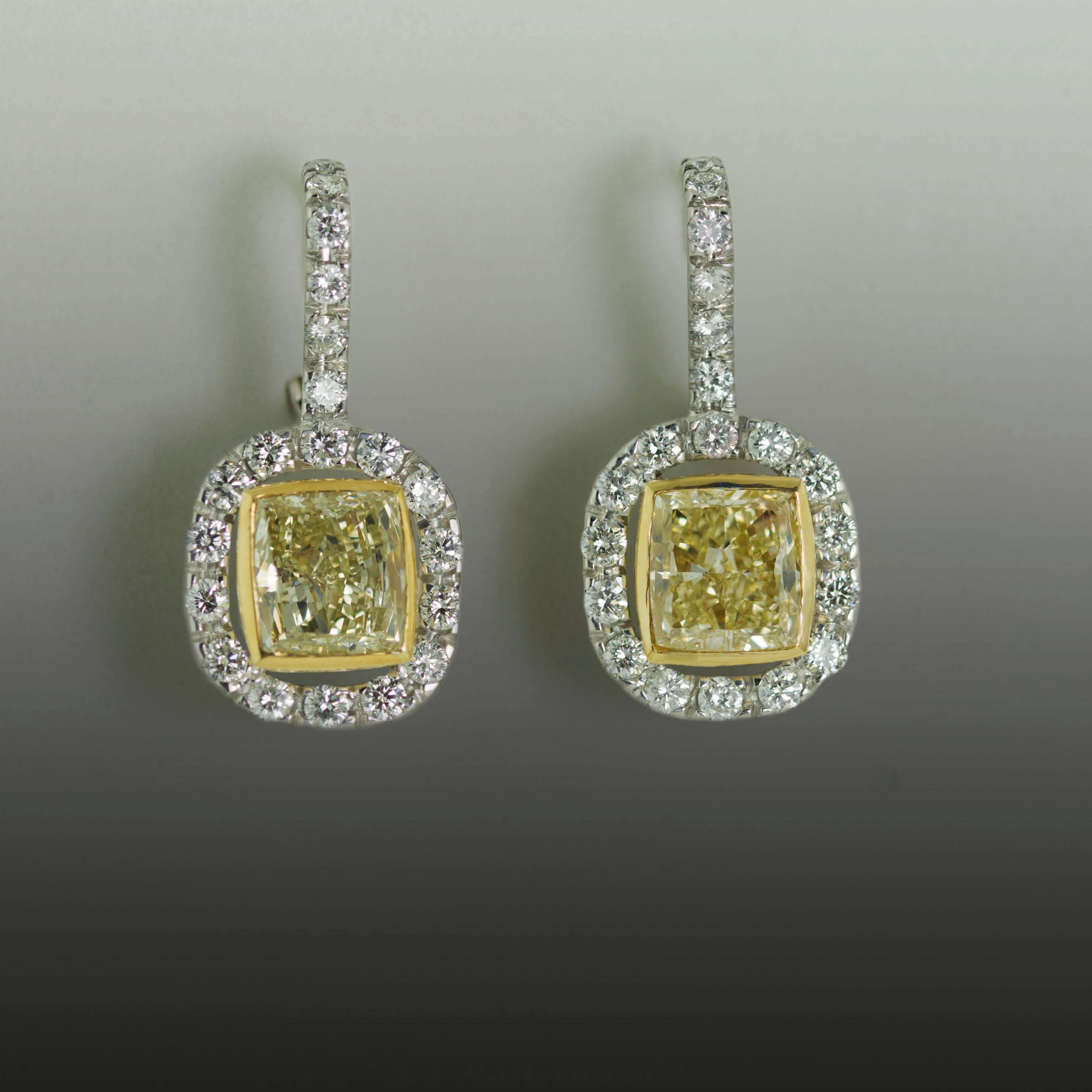 18k White and Yellow Gold Earrings with 2 Yellow Radiant Cut Diamonds weighing 4.70 carats and 40 Round Brilliant Diamonds weighing 1.47 carats 
