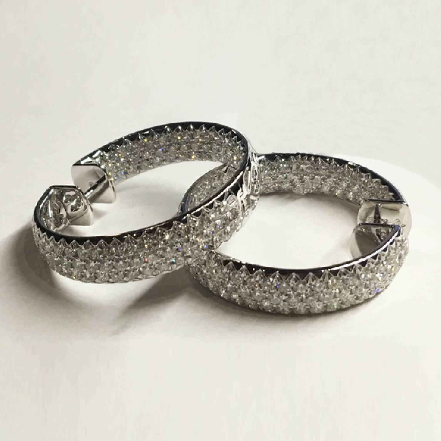 18k Hoop Earrings containing 8.07 carats of pave set F-G color VS+ round brilliant diamonds.
