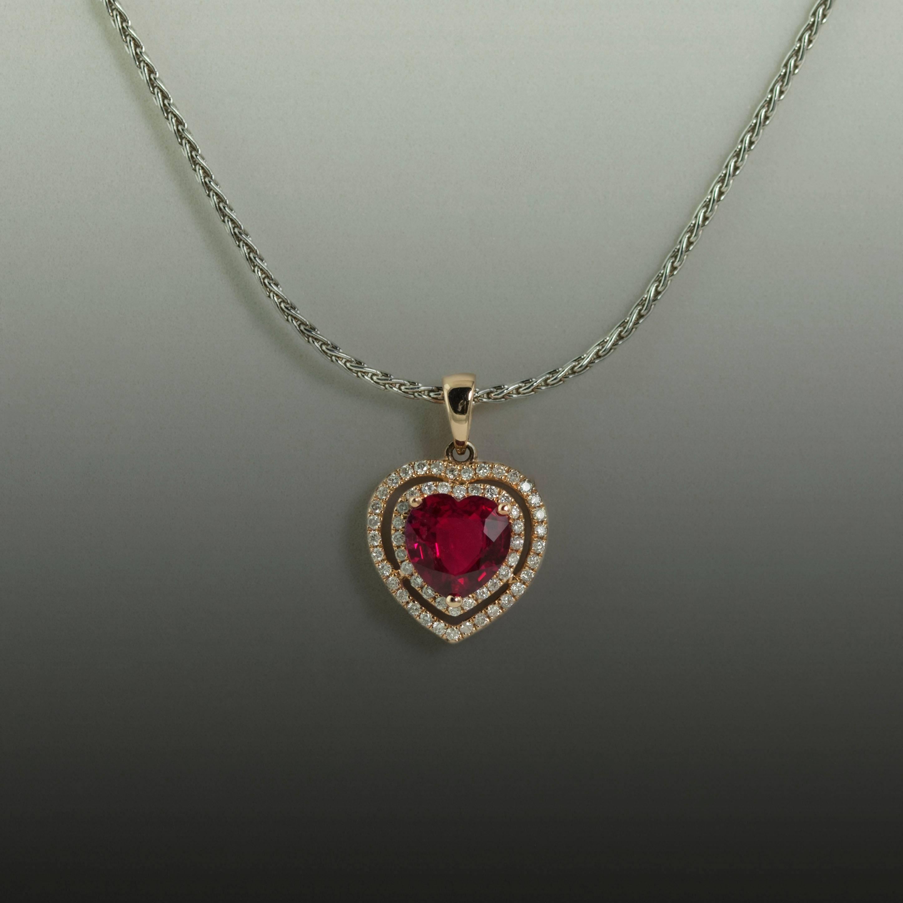 Beautiful 14K Pink Gold Pendant on a 14K White Gold Chain with 1 Heart Shaped Mozambique natural Ruby Weighing 1.58 Carats and 54 Round Diamonds Weighing 0.27 Carats. 