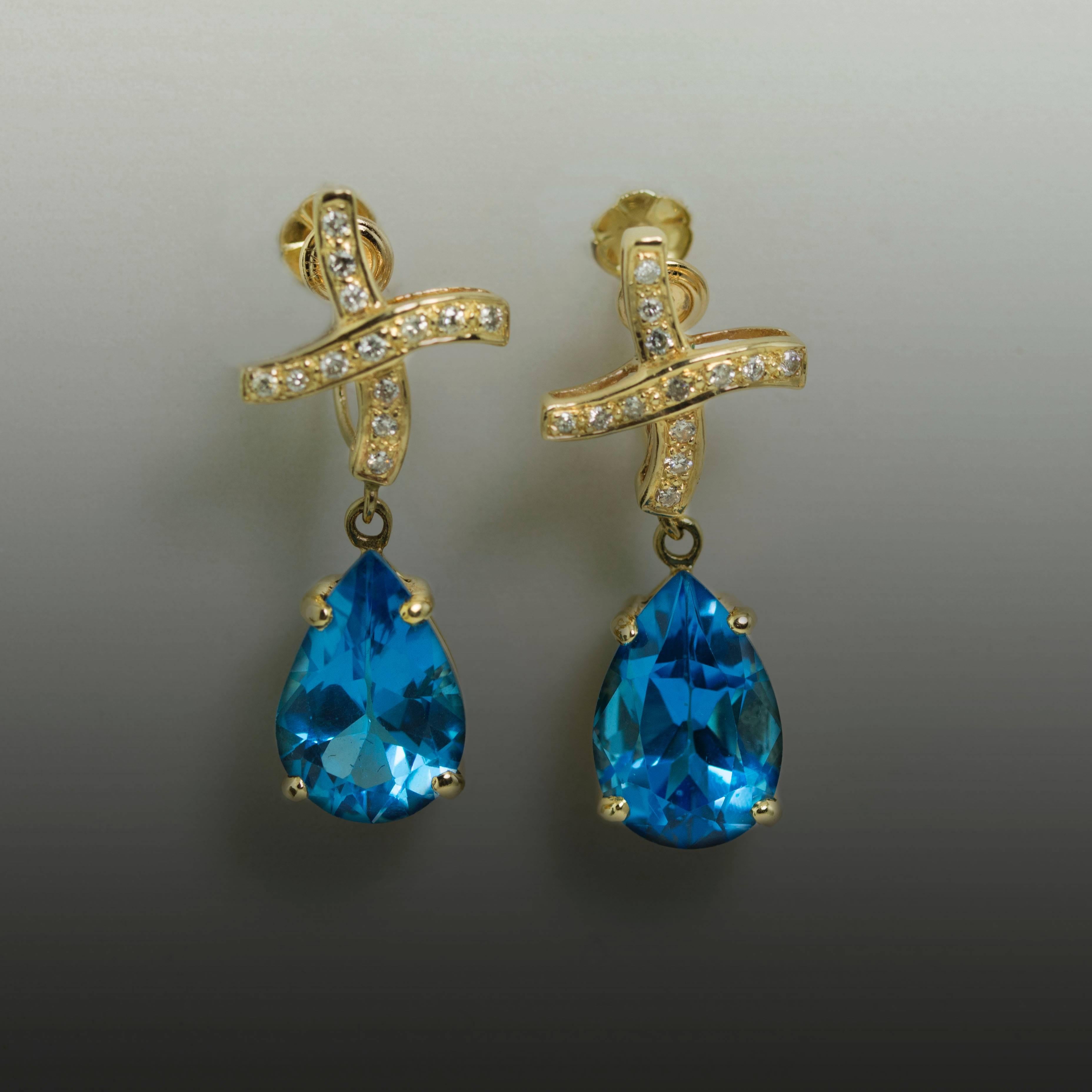 Beautiful 14K Earrings with 2 Pear Shaped Blue Topaz Weighing 13.06 Carats with 26 Round Diamonds Weighing 0.21 Carats. 