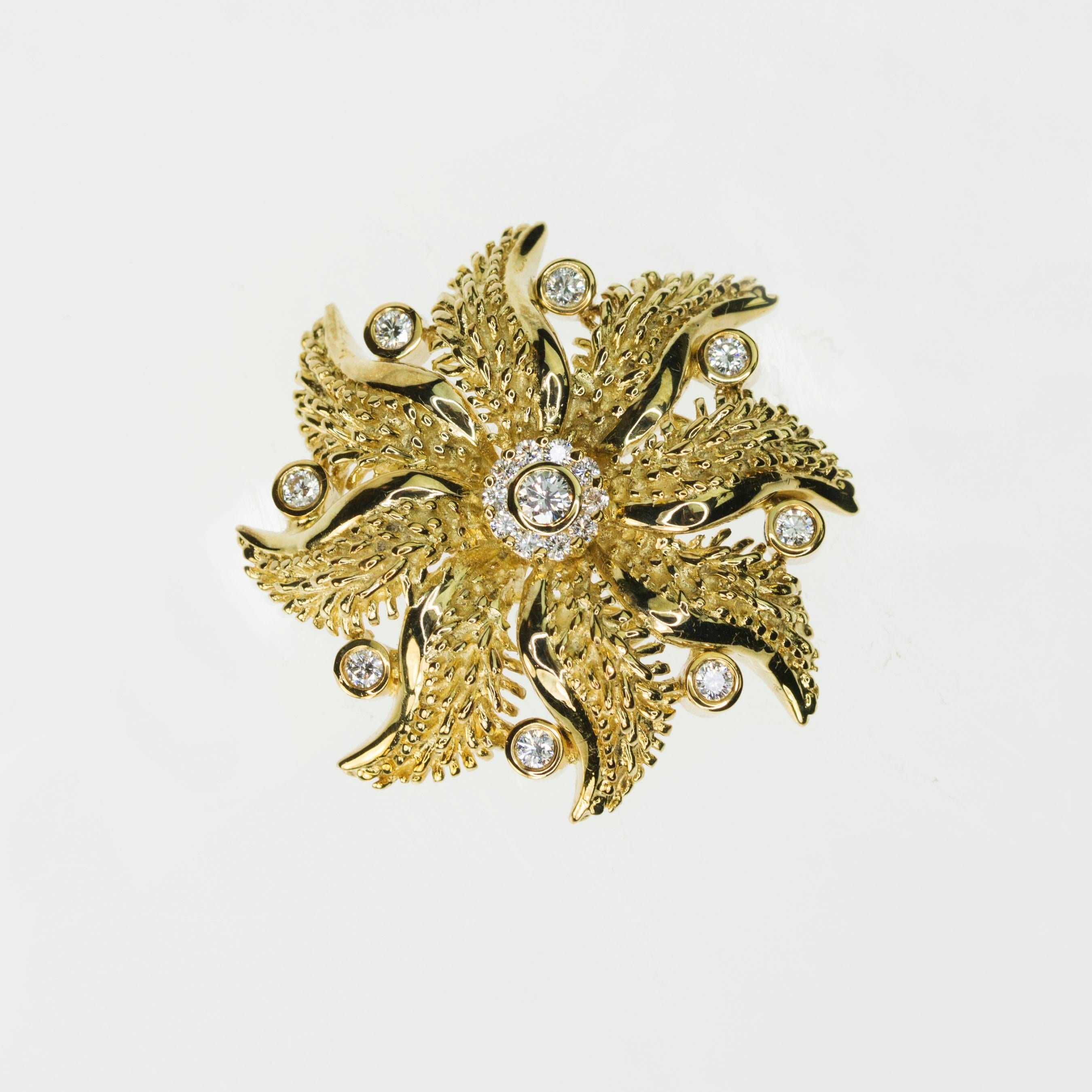 14k Floral Brooch 19 round brilliant diamonds weighing approximately 1.25 carats. 2 " wide and 18.66g of 14k gold.