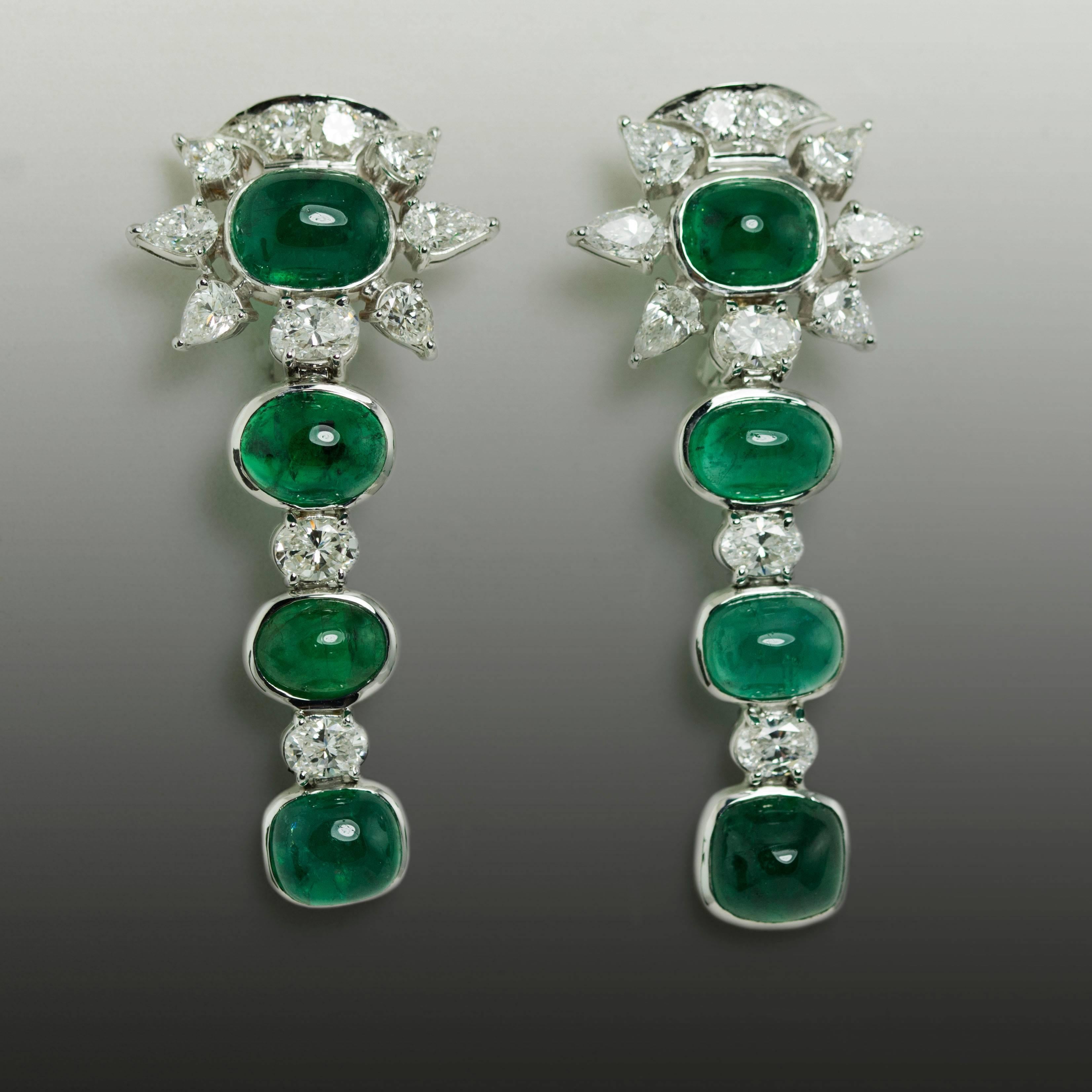 18k White gold earrings with 8 cabochon emeralds weighing 18.75 carats and 22 round brilliant, pear shape and oval diamonds weighing 4.09 carats.
