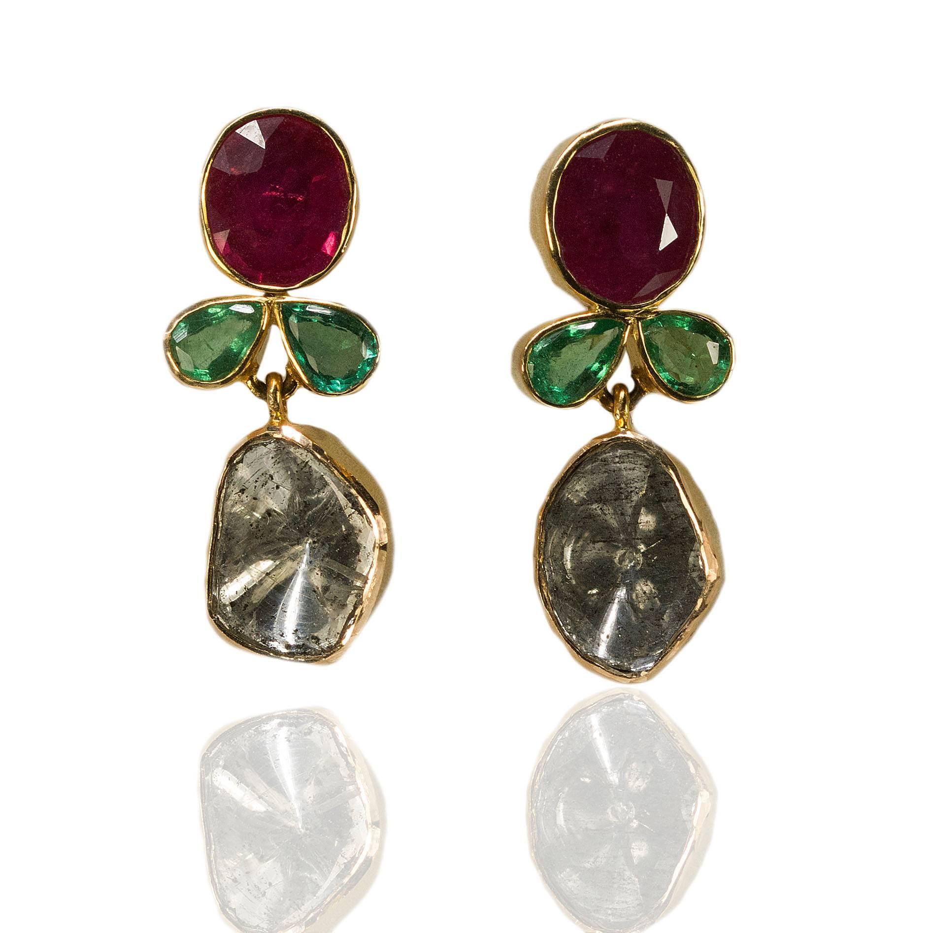 18k Fancy Earrings with 2 oval rubies weighing approximately 3.50 carats, 2 buff top, foil back diamonds weighing approximately 2.00 carats, 4 pear shape emeralds weighing approximately 1.20 carats, 5.89g