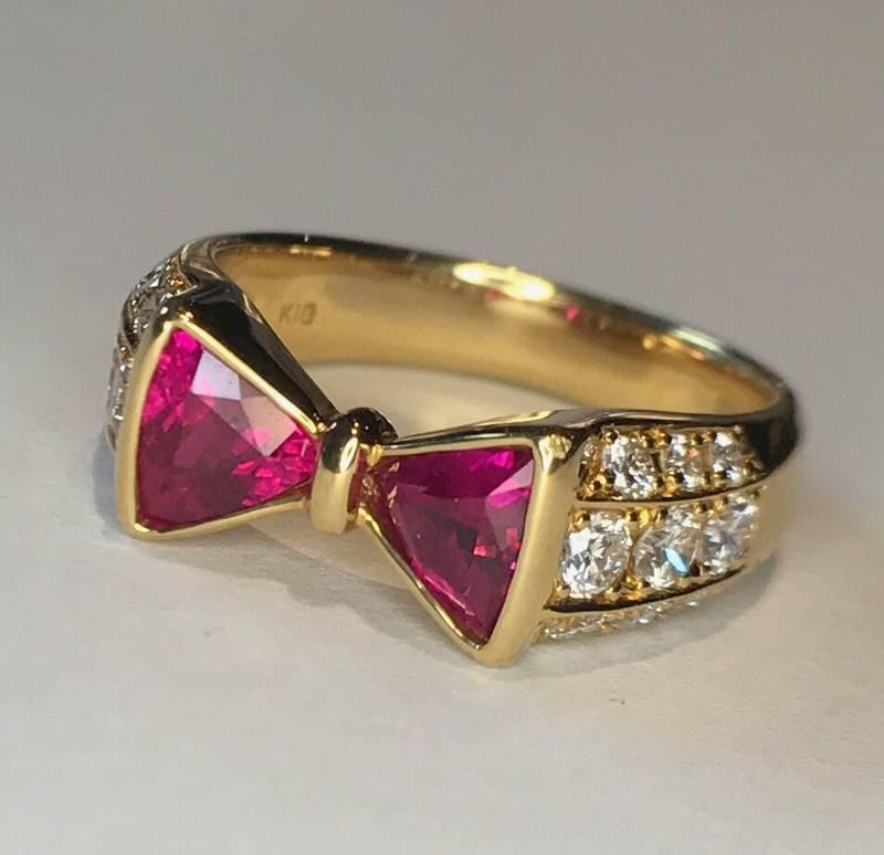 18k Bowtie Ring with two Trillion cut natural rubies weighing 0.95 carats and 18 modern round brilliant diamonds weighing 0.55 carats, 5.75g