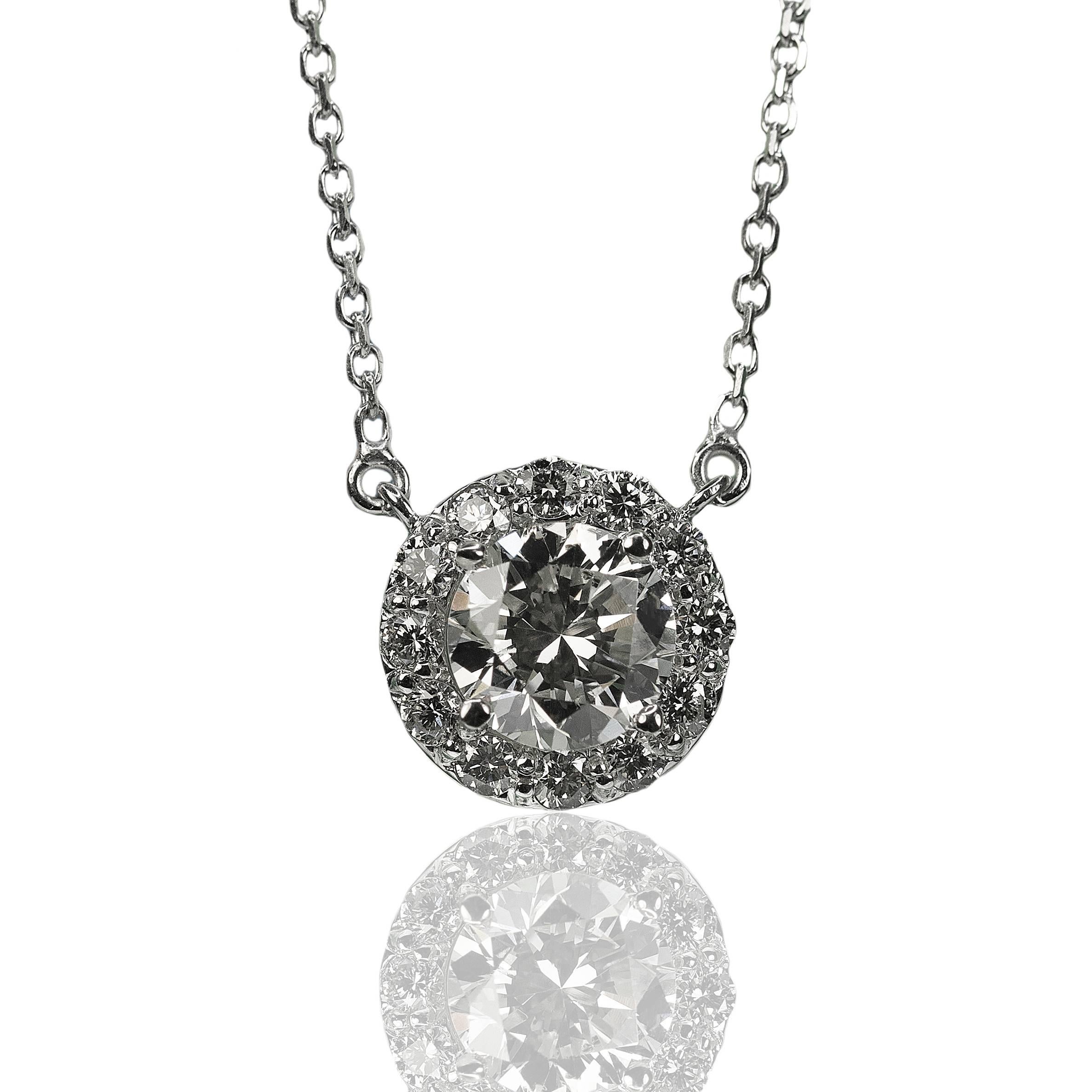 14k White Gold Necklace with one 1.07ct round brilliant surrounded by twelve smaller round brilliant diamonds weighing 0.31ct, 16