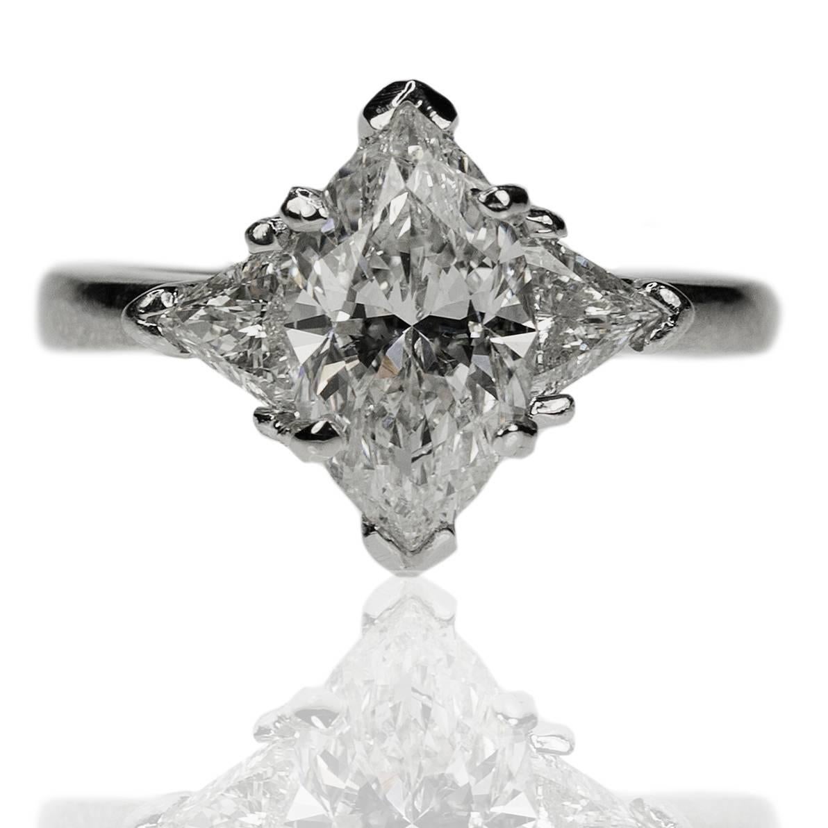 Platinum ring with 2.04 carat marquis cut diamond and two trillion cut diamonds weighing approximately 0.60 carats.