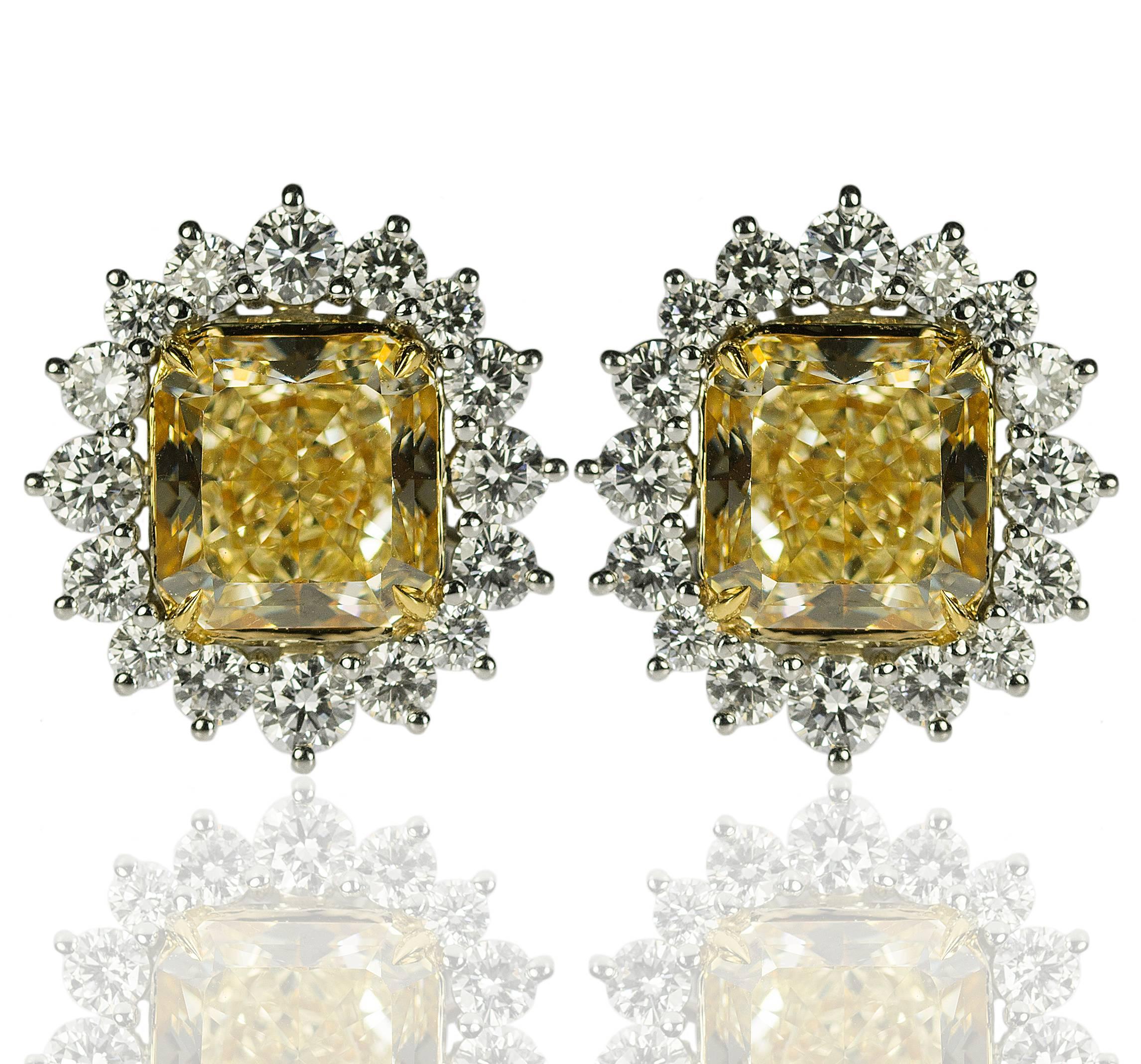 Daziling platinum & 18k Earrings Containg two GIA certified 'Fancy Yellow" diamonds weighing 8.16 carats total weight and one being certified as Fancy Yellow VVS2 clarity and the other being Fancy Yellow VS1 carity. The yellow diamonds are