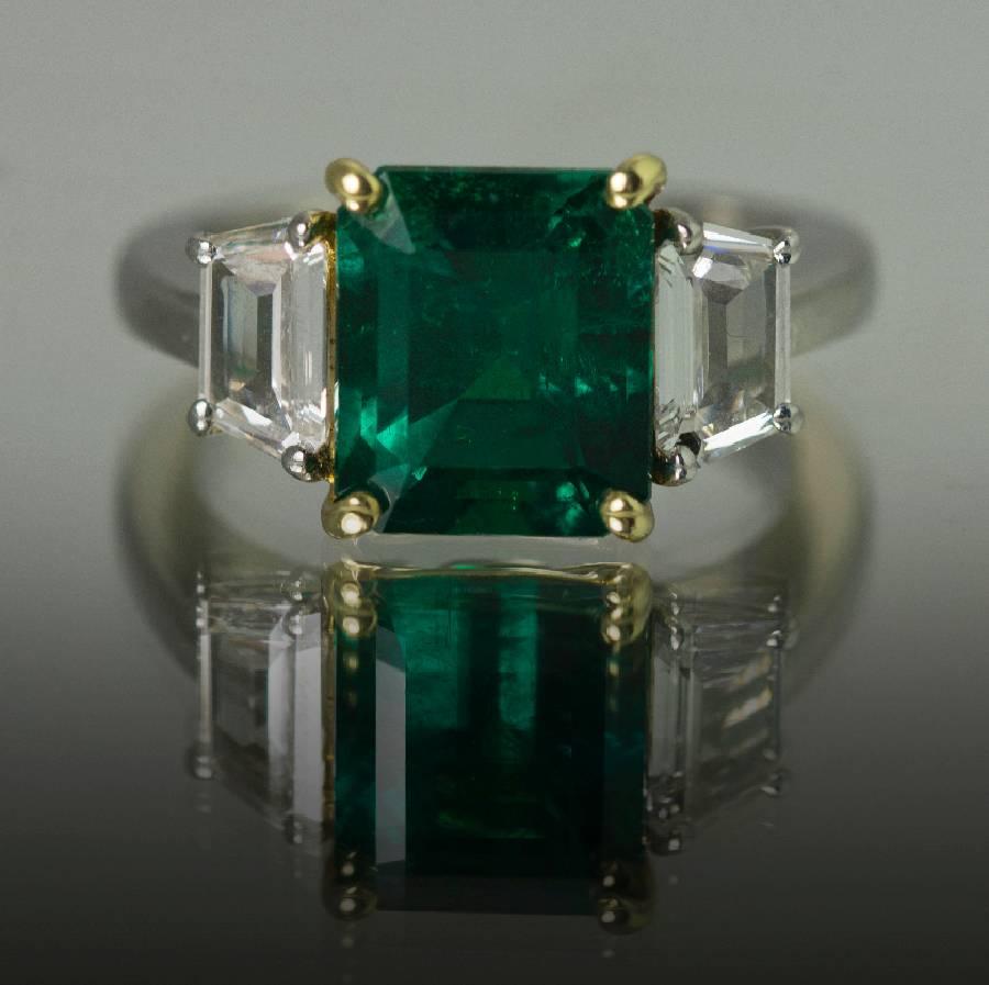 Super Gem Quality 3.88 carat Colombian Emerald with Gubelin certificate stating only minor enhancement. Set in hand fabricated platinum ring with two D-E color VS+ clarity shield cut diamonds weighing 1.02 carats.