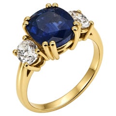 Natural cushion Sapphire and oval diamond three stone ring