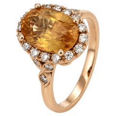 An 18k rose gold sapphire and diamond cluster ring