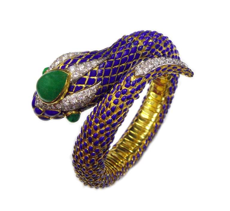18K Yellow Gold
Blue Enamel 
The head set with round diamonds and three cabochon emeralds.
Inner circumference - 5 1/2