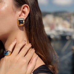 Bulgari. A blue topaz and gold demi-parure— a pair of ear clips and a ring