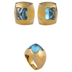 Bulgari. A blue topaz and gold demi-parure— a pair of ear clips and a ring