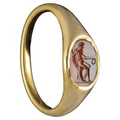 A Renaissance gold ring set with a carnelian intaglio. Old man seated on a rock