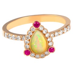 14K Gold Ring with Natural Ruby Accents and Pear-Shaped Opal with Diamond Detail