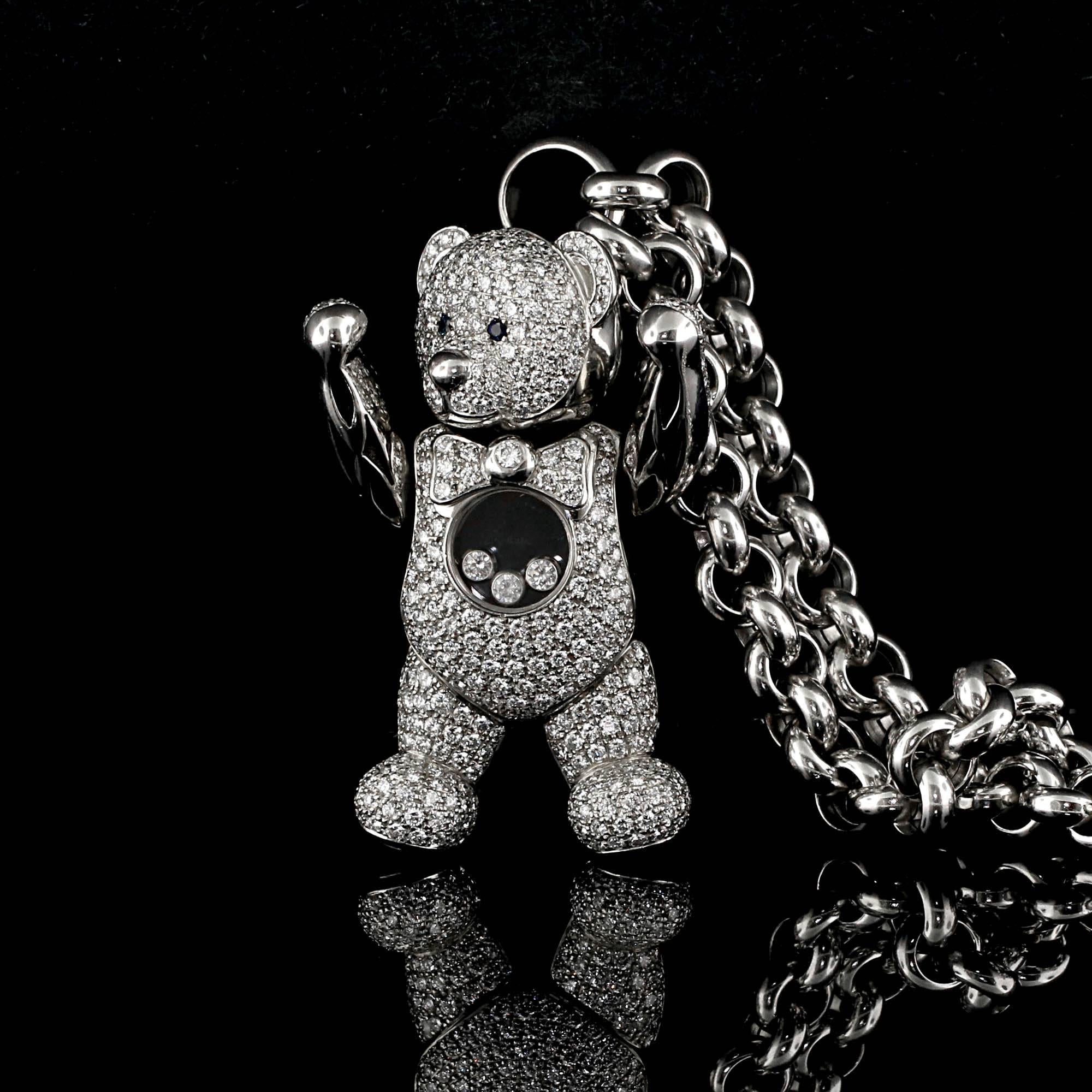 
Filled with 3 happy diamonds, this movable dancing bear necklace is adorned with over 8 carats of diamonds and .04 carats of sapphire. The sapphires are located in the eyes where as the diamonds cover the entire front of the pendant. The hands on