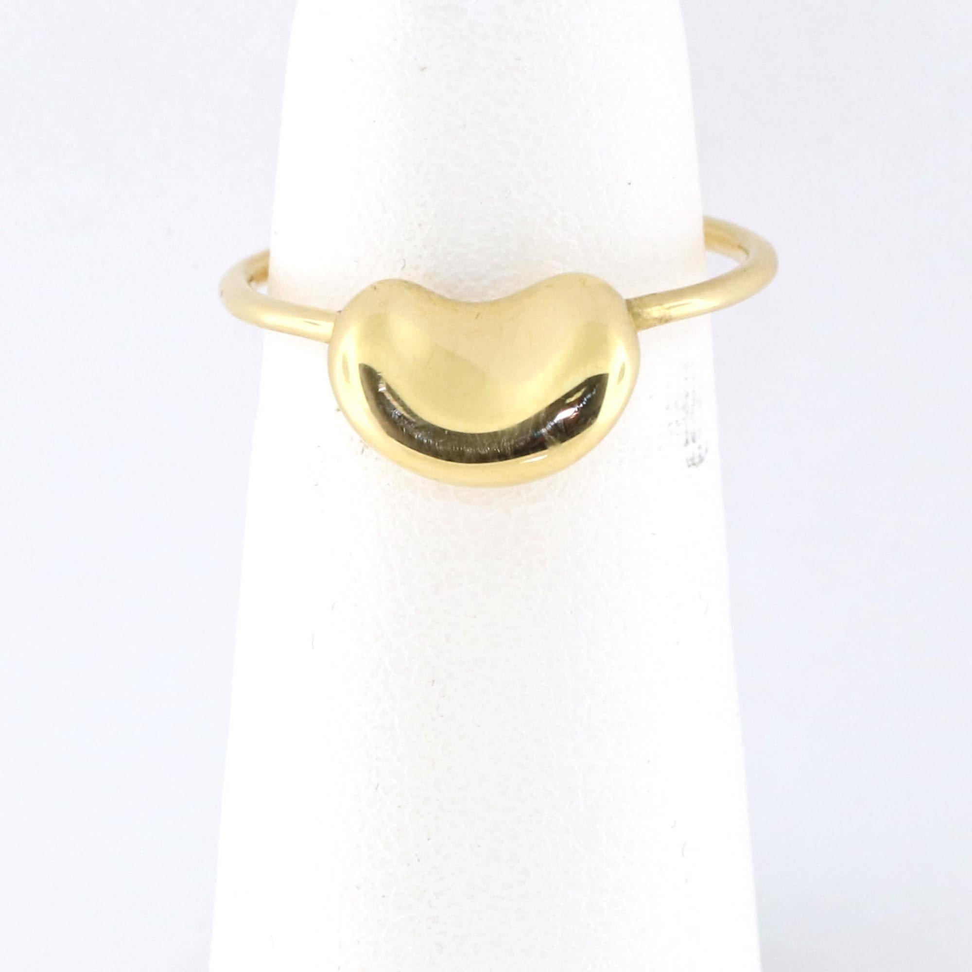 Tiffany & Co. Elsa Peretti 18k Yellow Gold Mini Bean Ring Size 5.5
This elegant bean ring is from the house of Tiffany & Co. designed by Elsa Peretti, it is well crafted from solid 18k yellow gold with a polished finish and boast a high polished